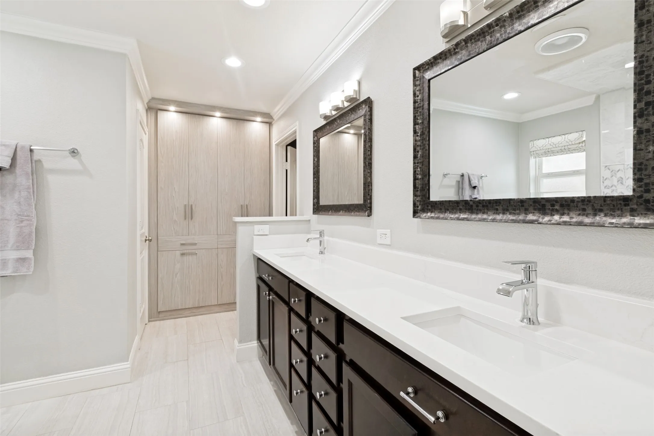 Remodeled primary bath features custom California Closet built ins.