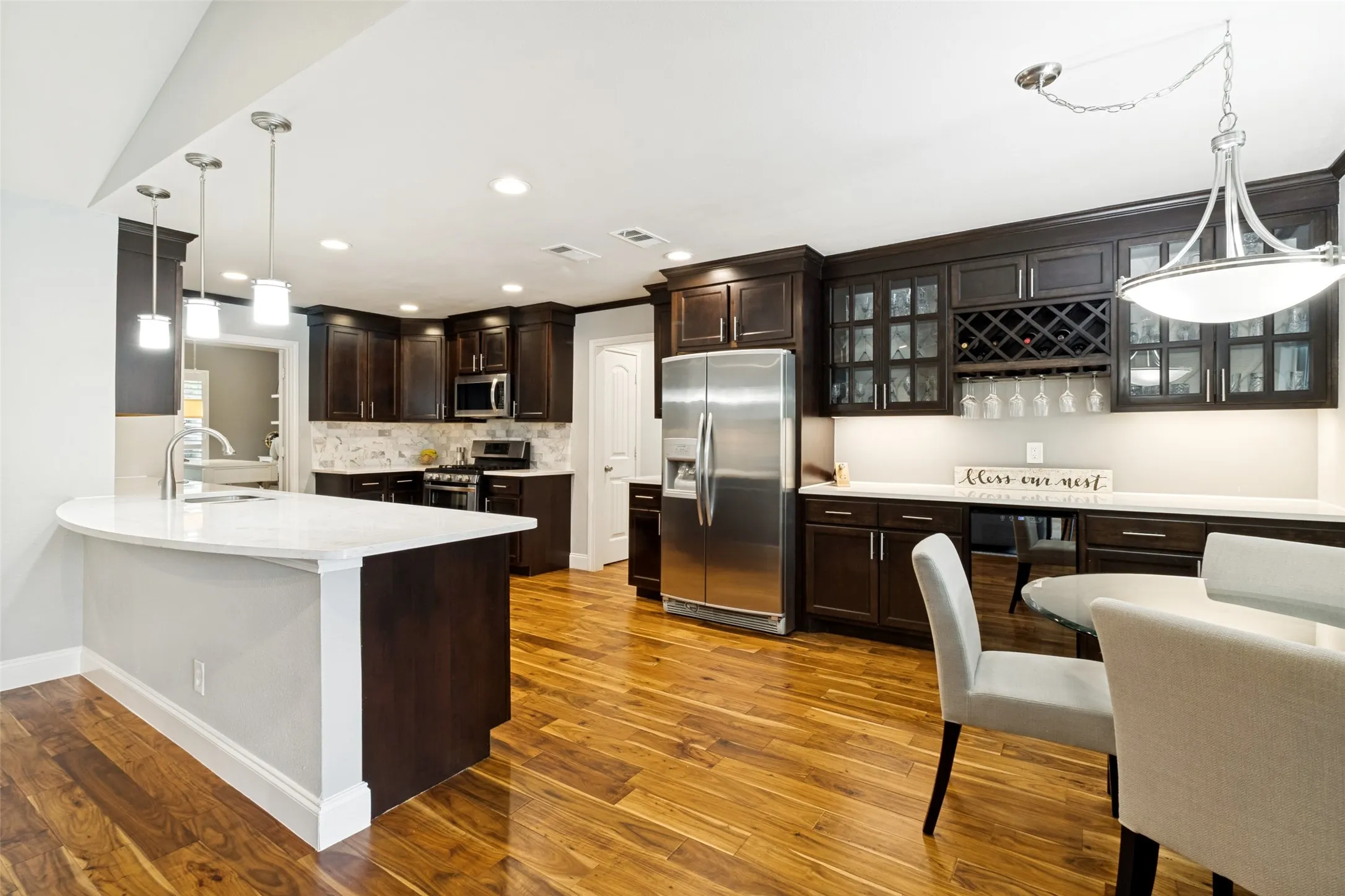 Remodeled eat in kitchen features quartz counters, abundant cabinet space.