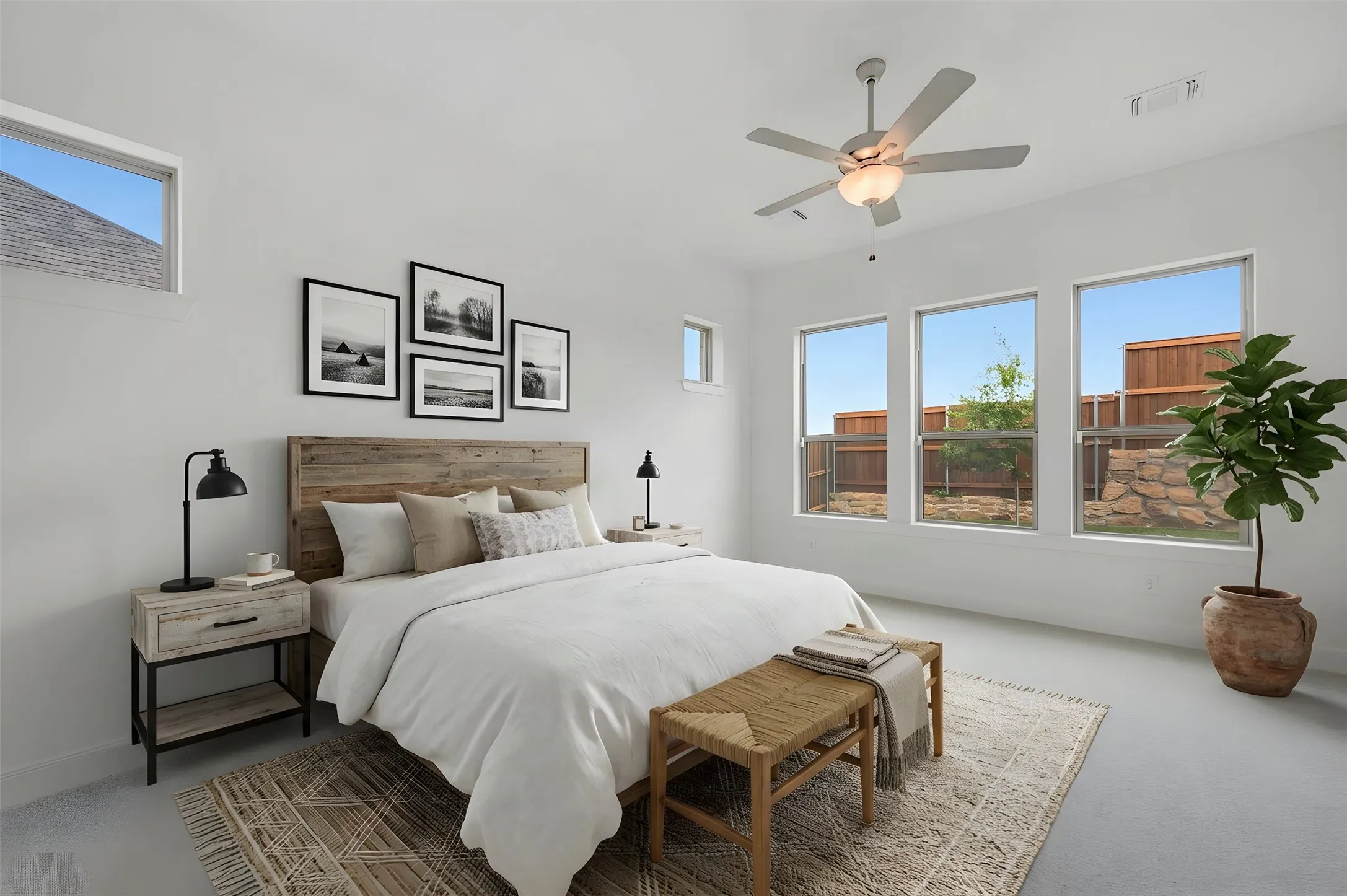 Recessed lighting, ceiling fan with integrated light, three large windows, and a high-set window