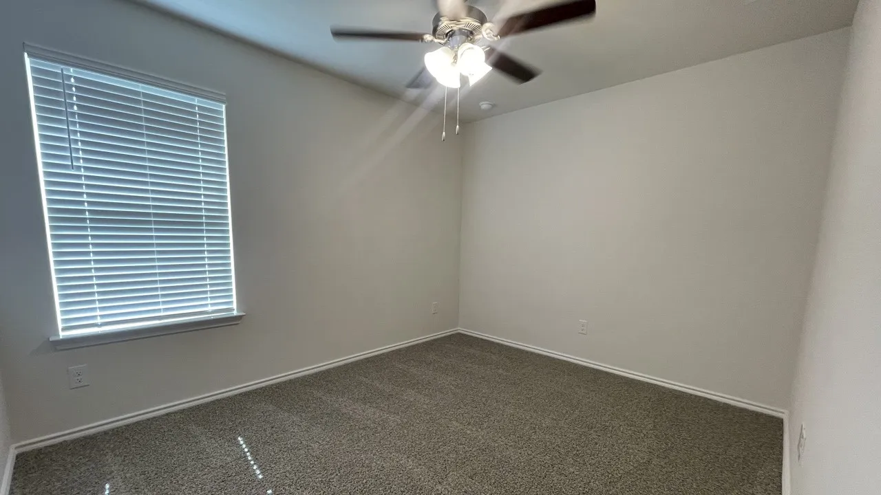 Neutral wall tones and gray carpet flooring
