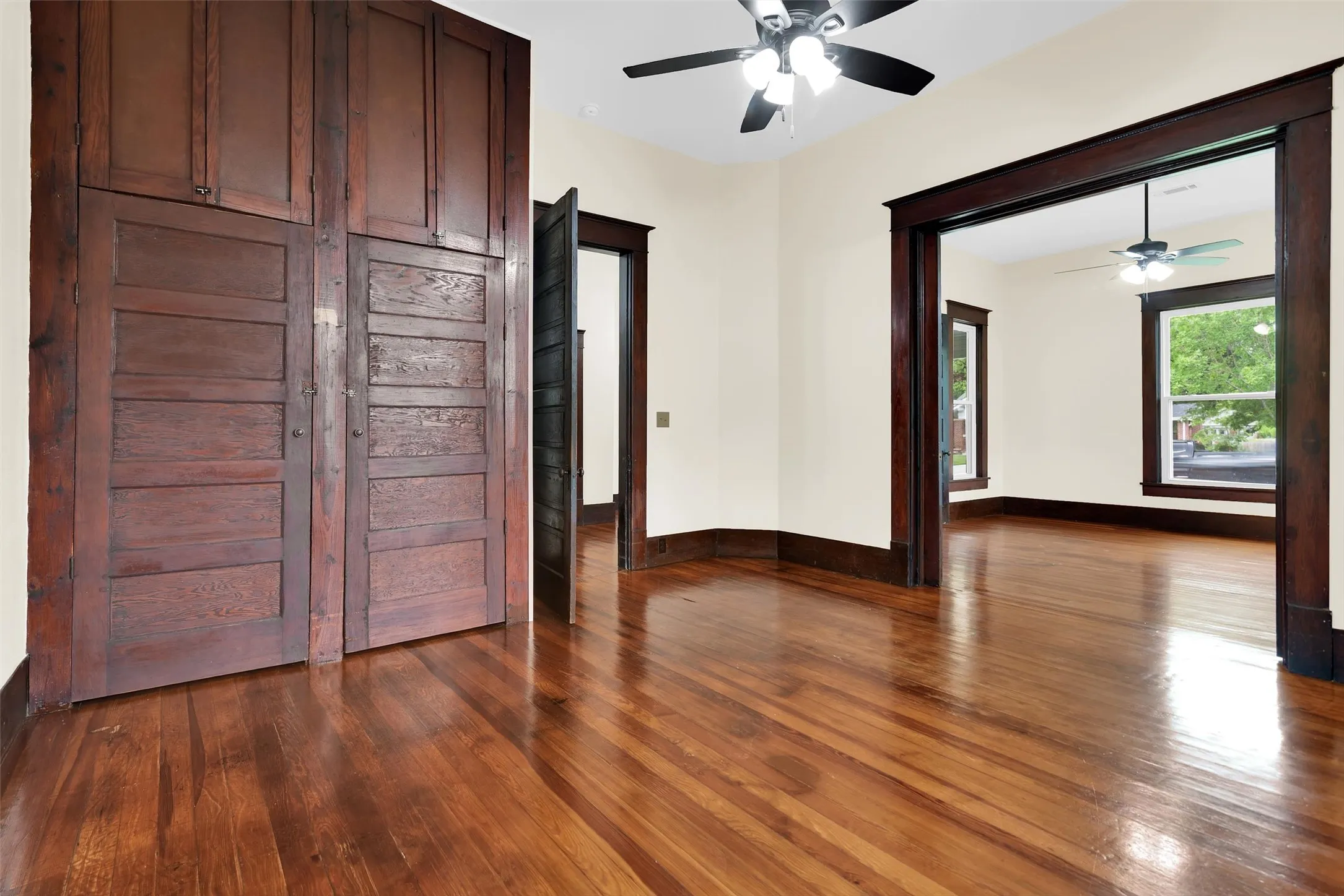 Room featuring neutral-toned carpeting, light-colored walls, and dark wood trim