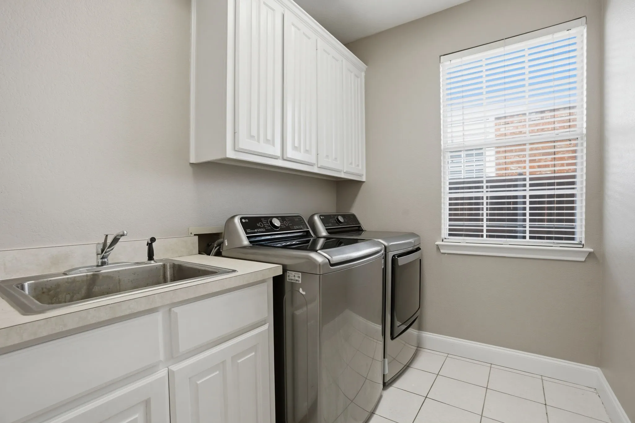 Downstairs laundry room with built in sink