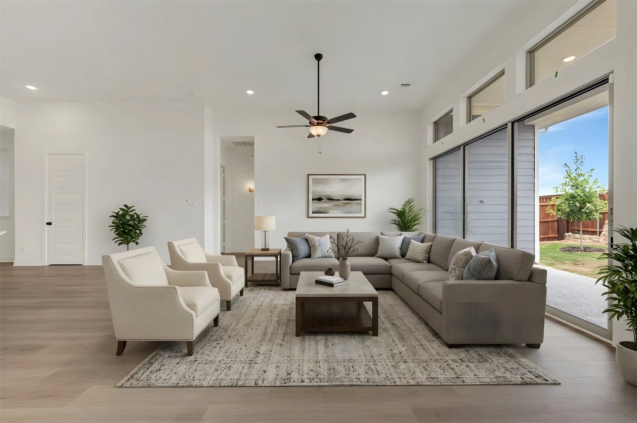 Vaulted ceilings, wood-finish flooring, recessed lighting, and a modern ceiling fan