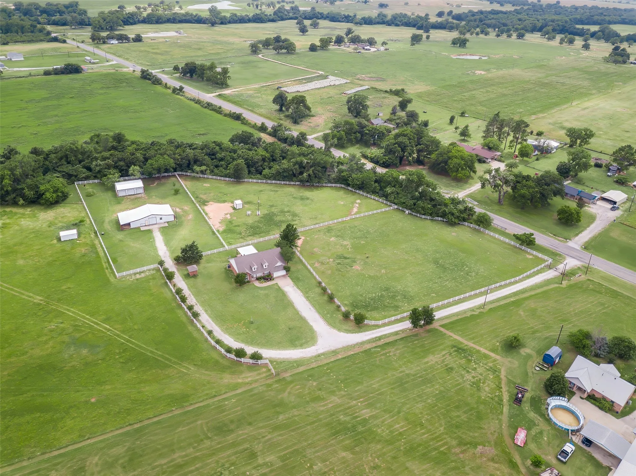 Land is fully fenced, and surrounded by trees.