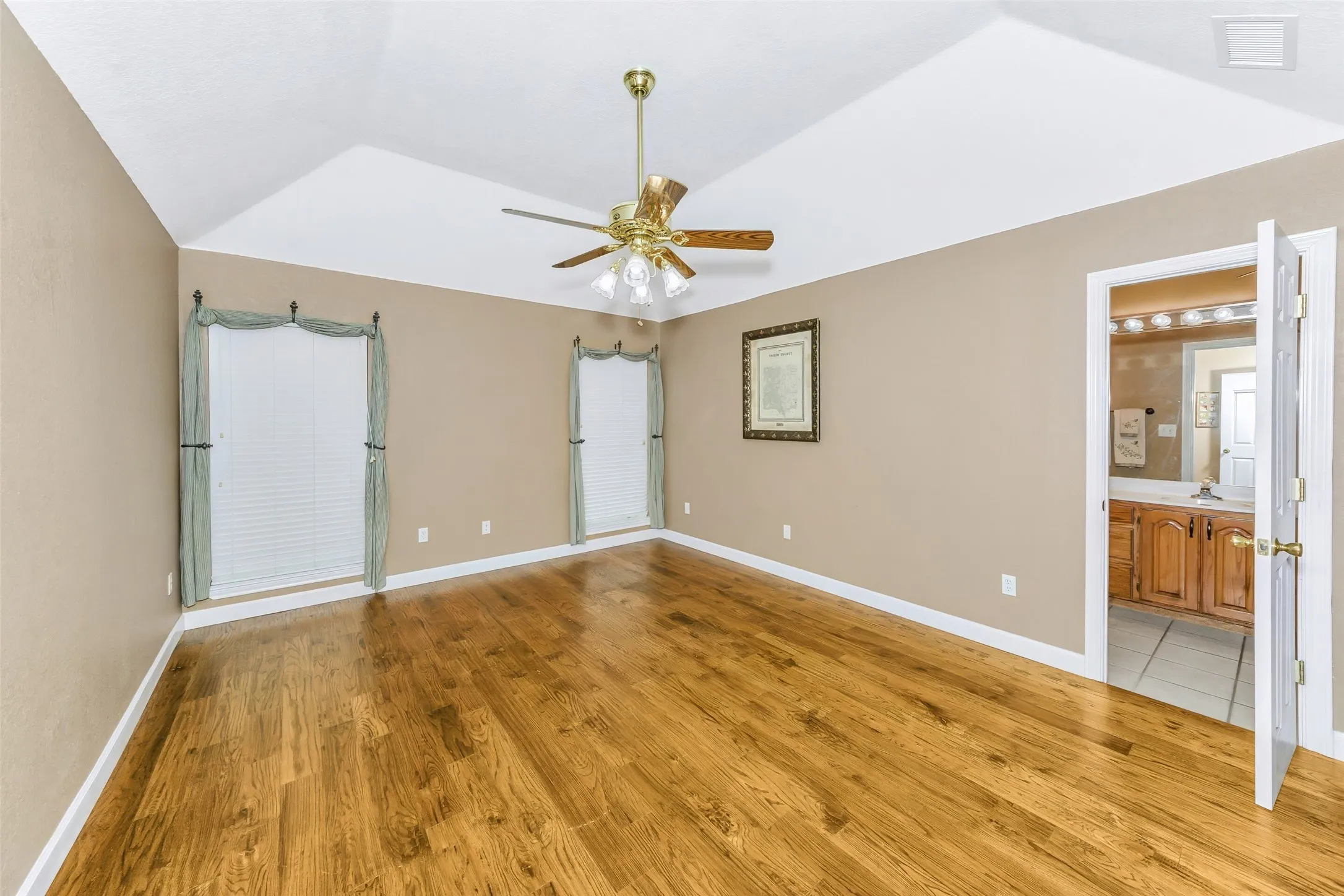 Hand-scraped wood floors with ensuite bath.