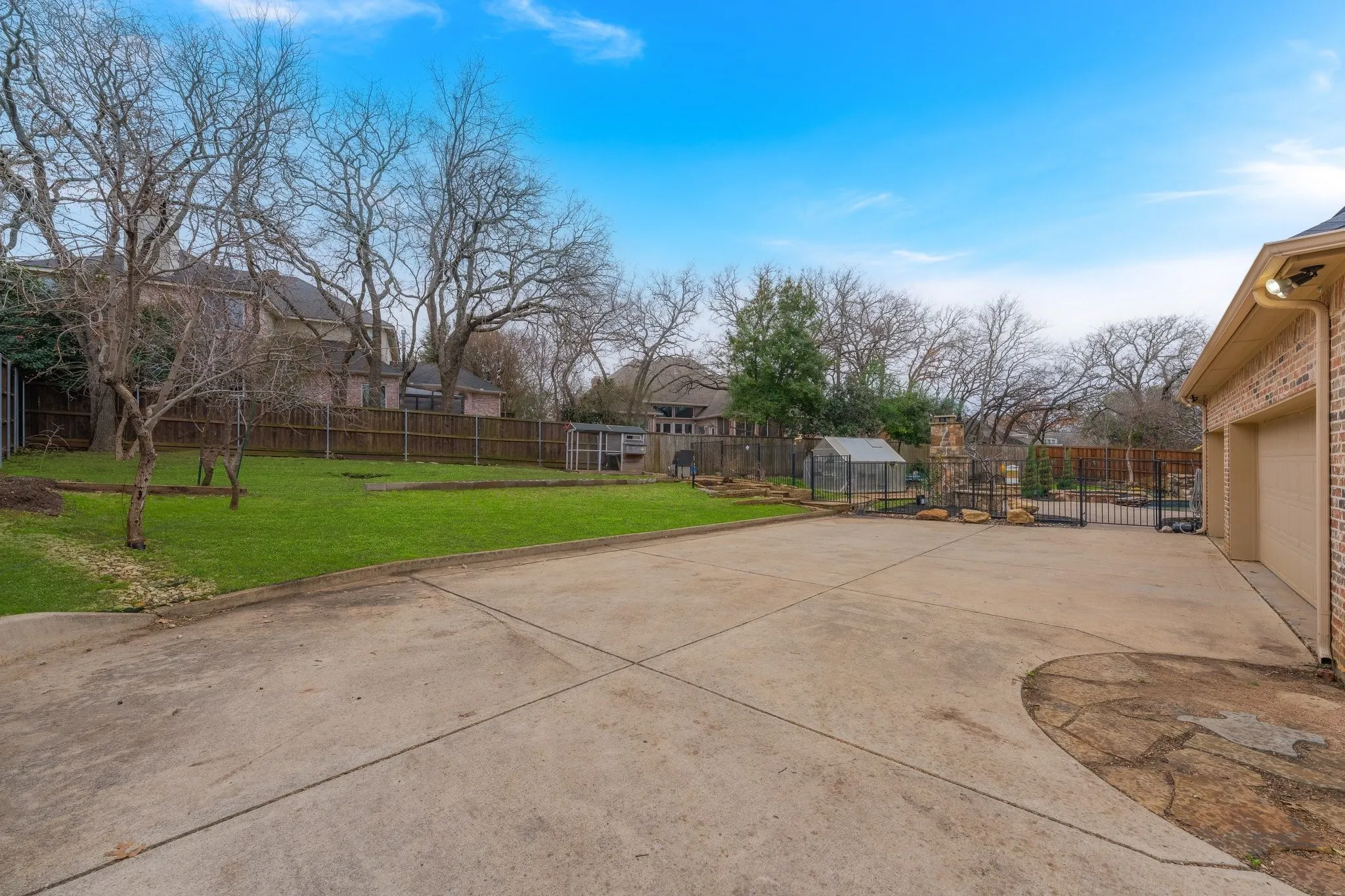 Expansive concrete driveway with stone inlay detailing