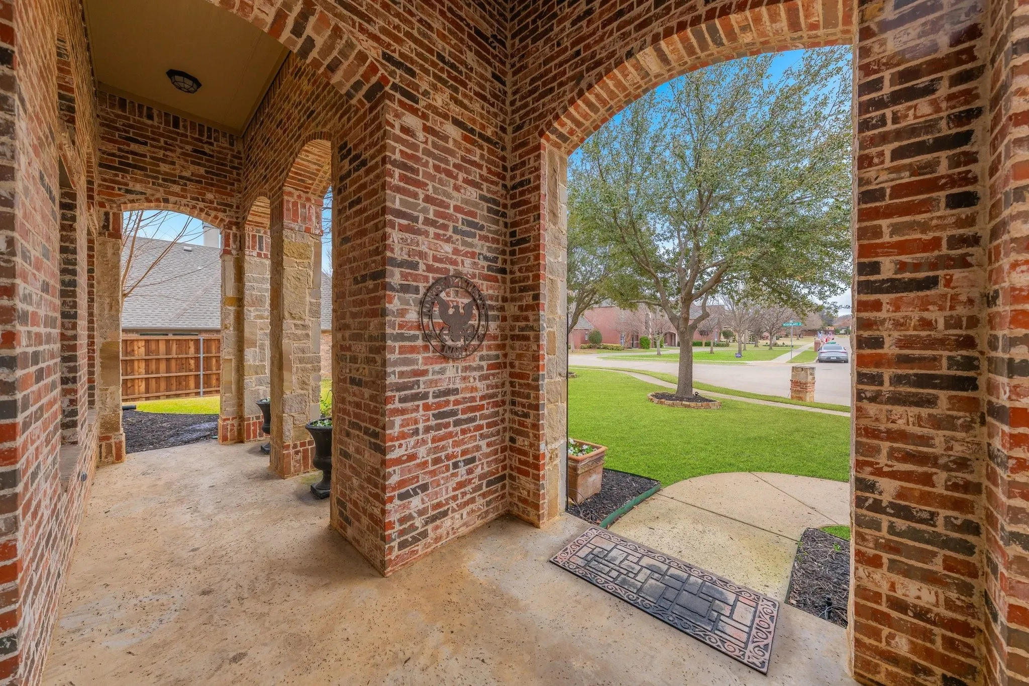 Brick exterior with an arched entryway and stone pillars