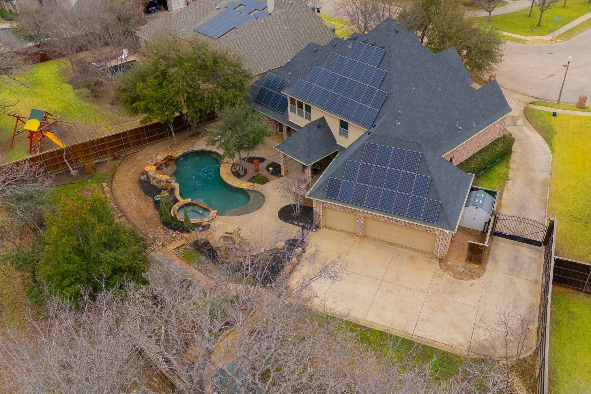 Spacious residential property with a multi-gabled roofline featuring solar panel arrays
