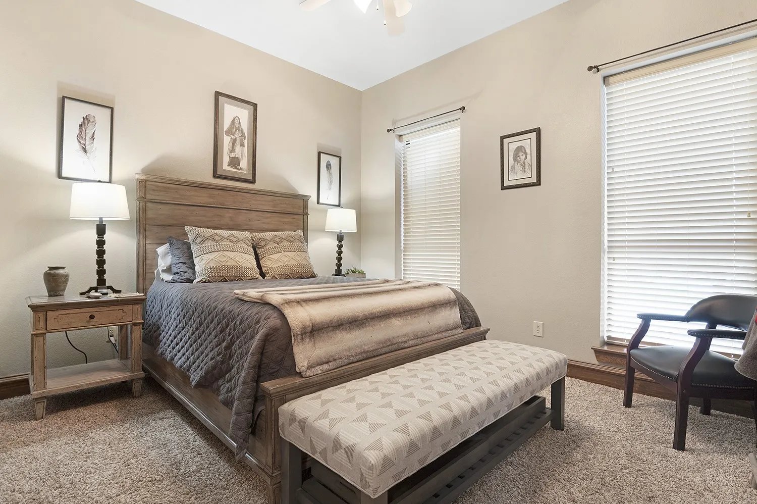 Carpeted room featuring light-toned walls and dual windows with blinds