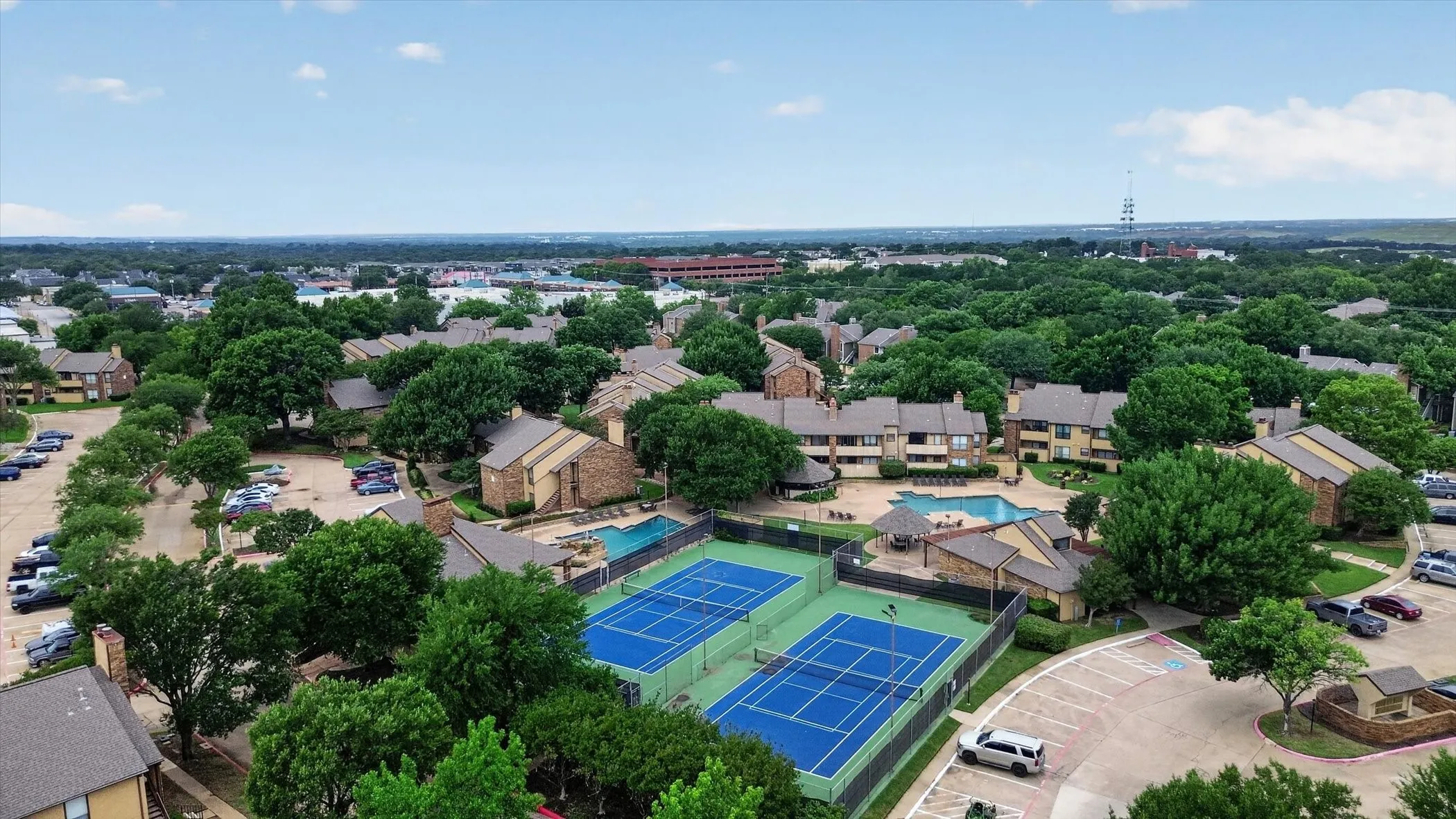 Community amenities featuring two tennis courts, two swimming pools, and extensive parking areas