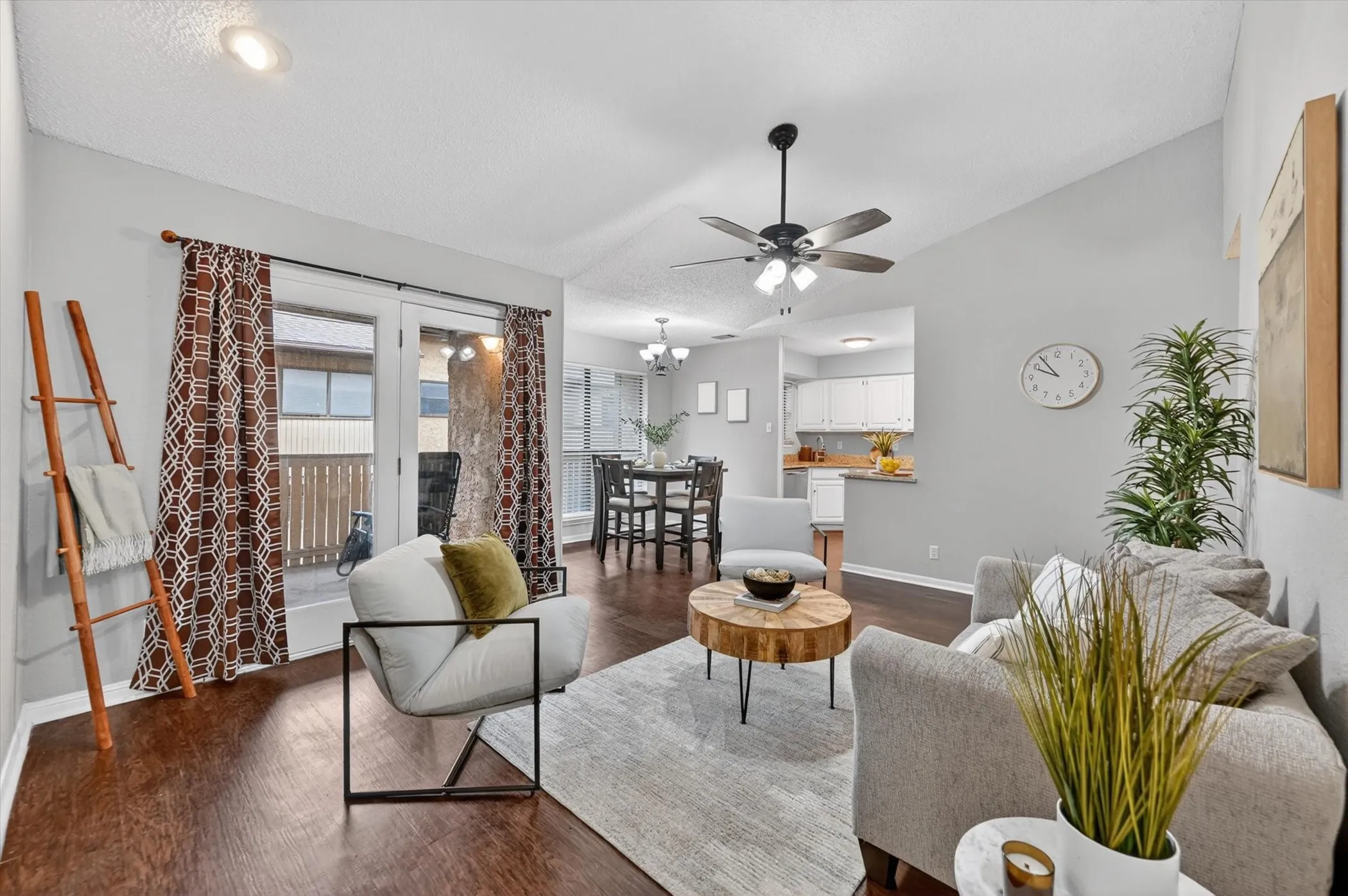 Spacious living area featuring wood-finish flooring, a ceiling fan, and recessed lighting