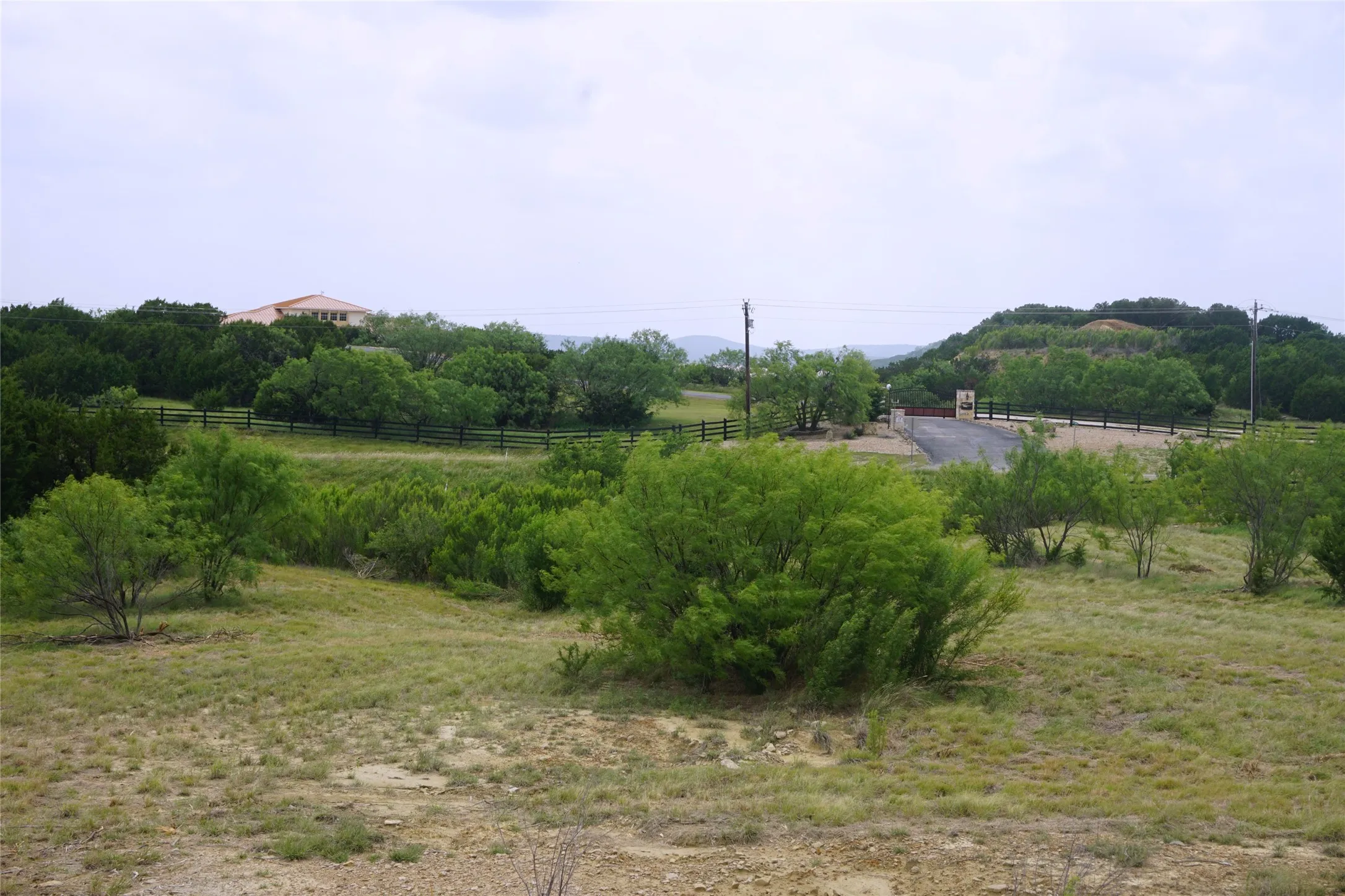 The community clubhouse across the street and its lake view can be seen from this lot.