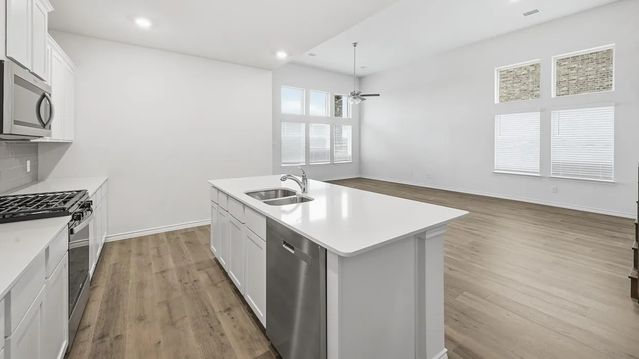 Kitchen island with a double basin sink and stainless steel dishwasher