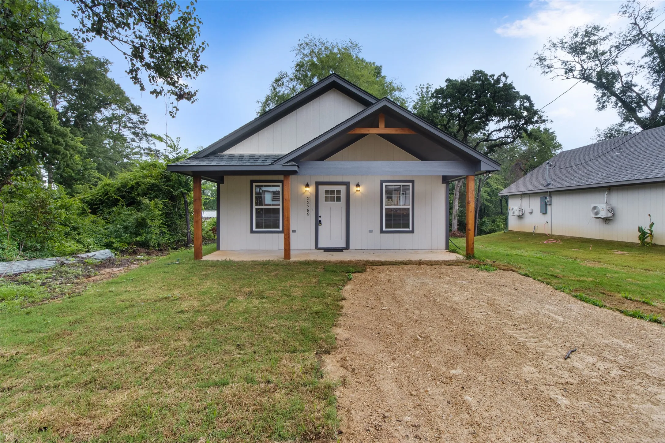 Modern farmhouse exterior featuring light-colored siding and dark trim