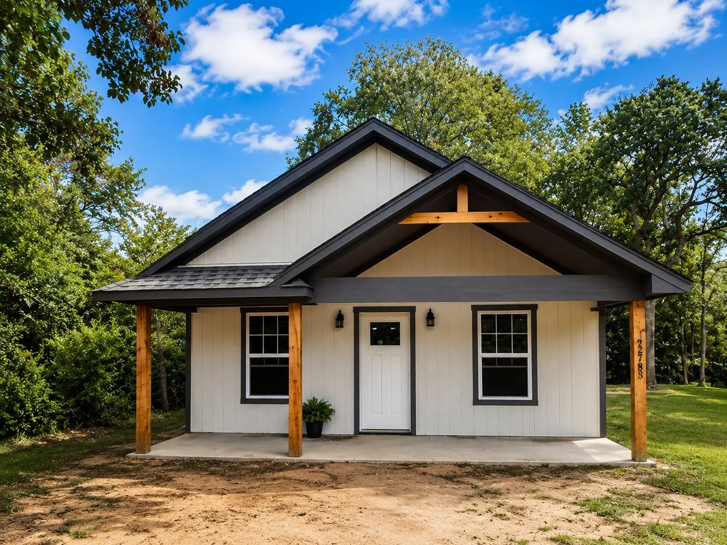 Modern farmhouse exterior featuring white vertical siding and dark trim