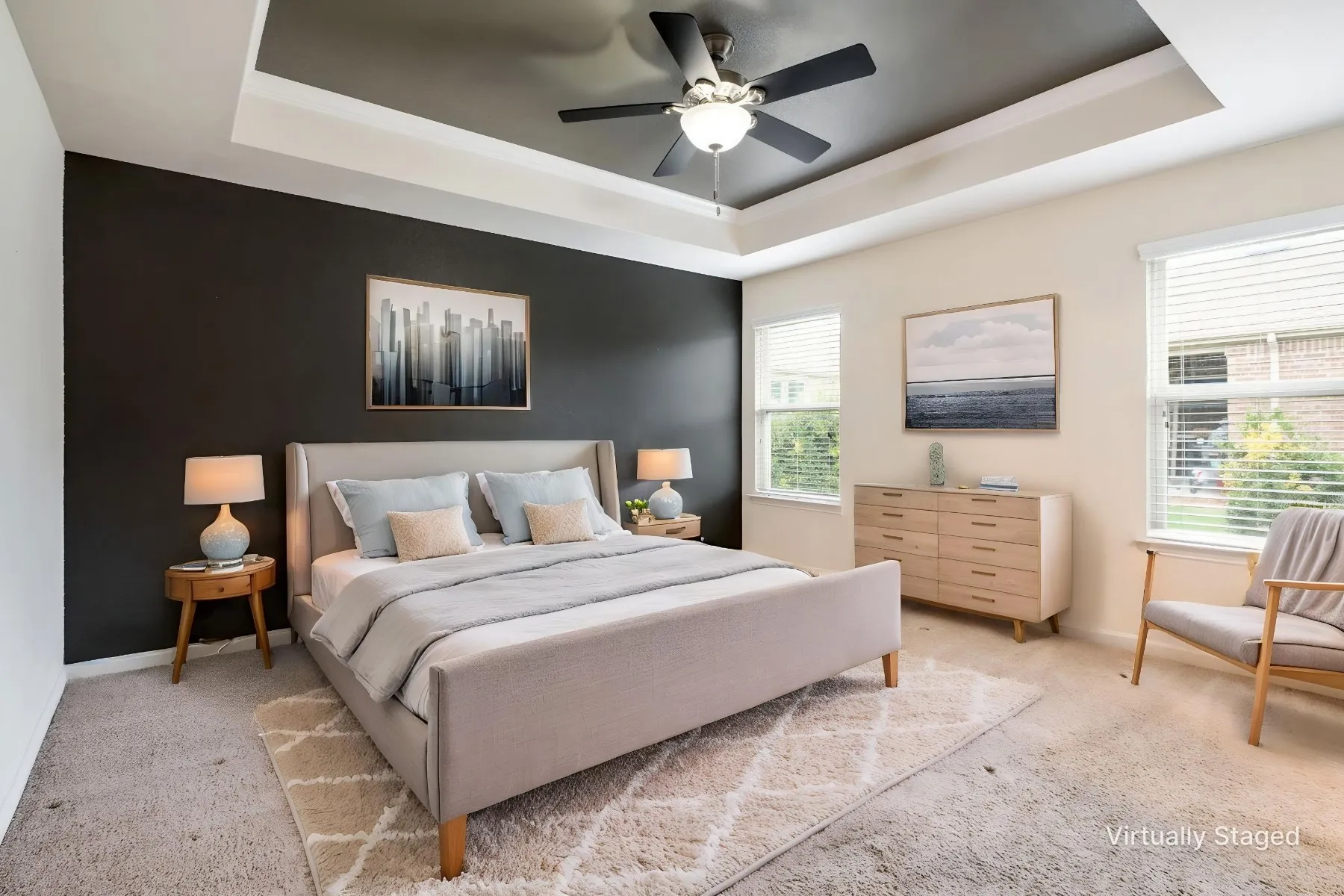 Virtually Staged Primary Bedroom with tray ceiling and accent paint.