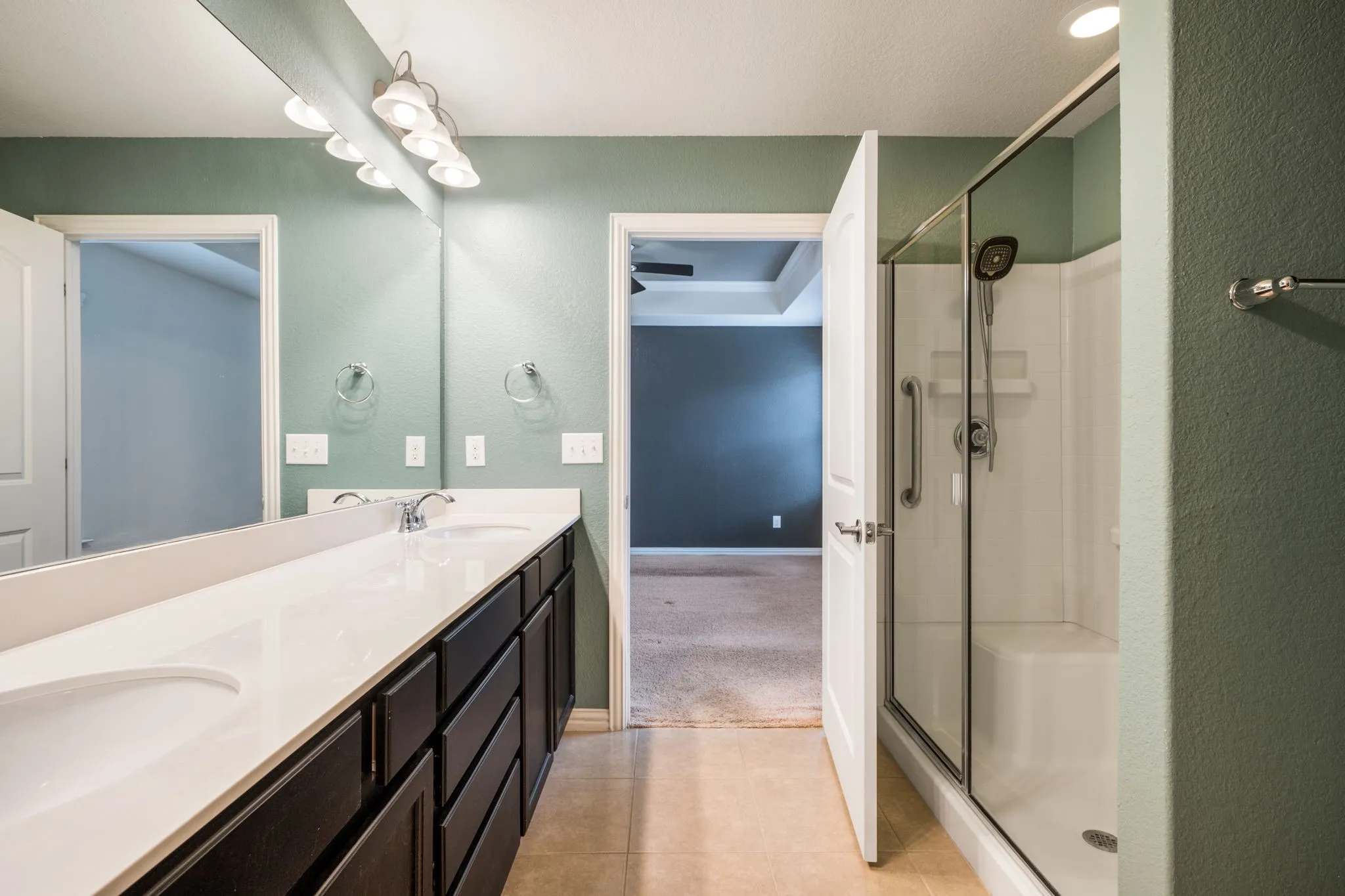 Dual sinks, walk-in shower in primary en-suite bath.