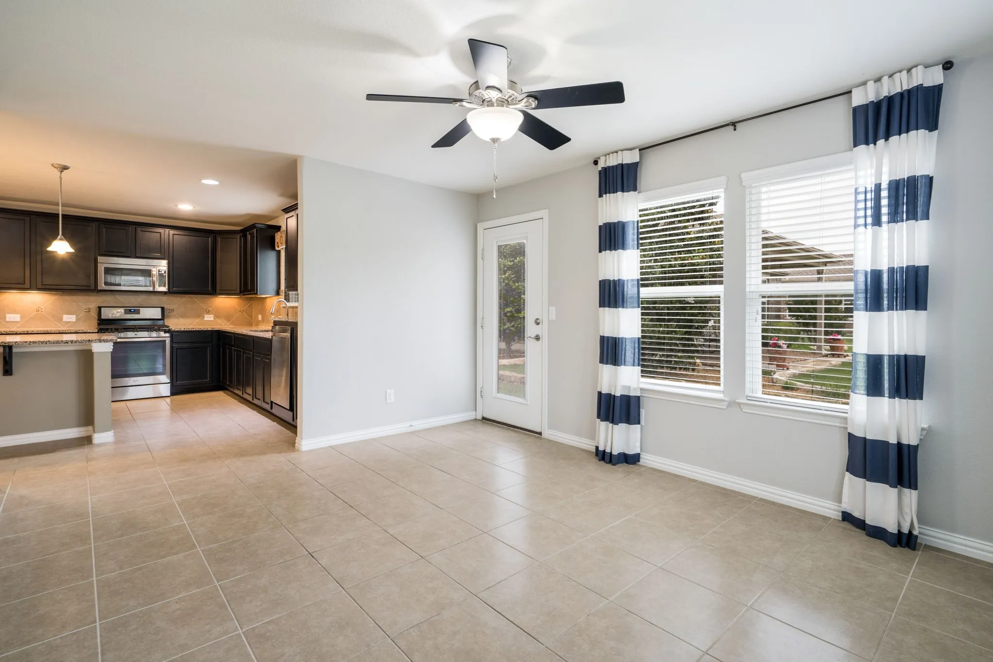 Den-Sunroom off kitchen with access to backyard.  Light pours in these large windows!