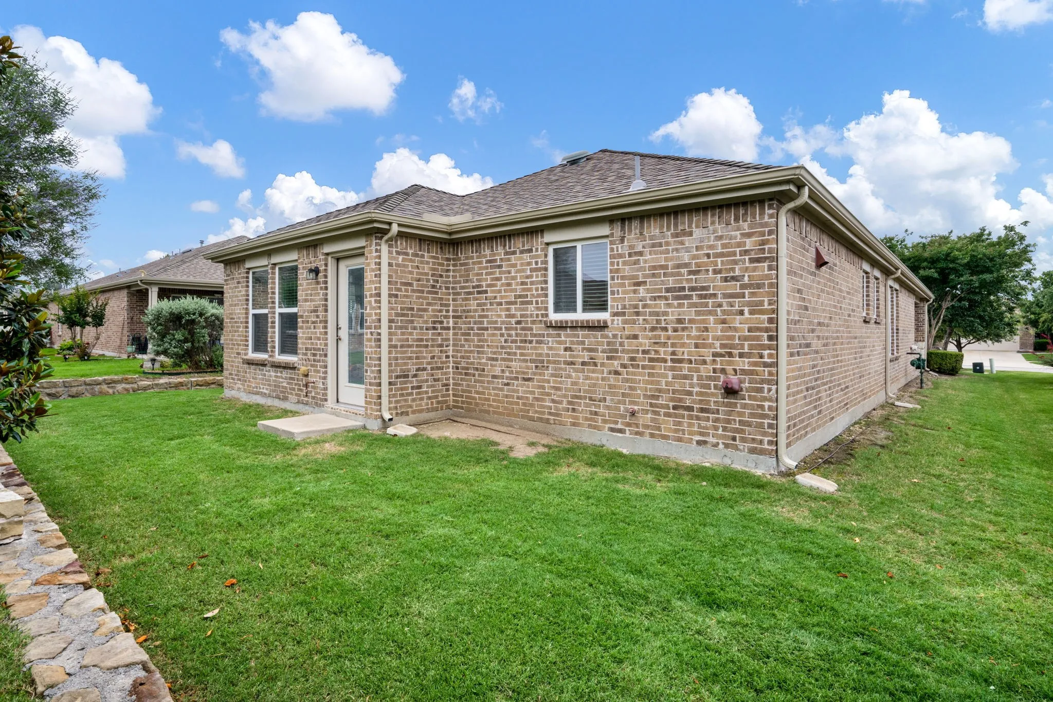 Plenty of grassy area on all sides of the house (no fence).