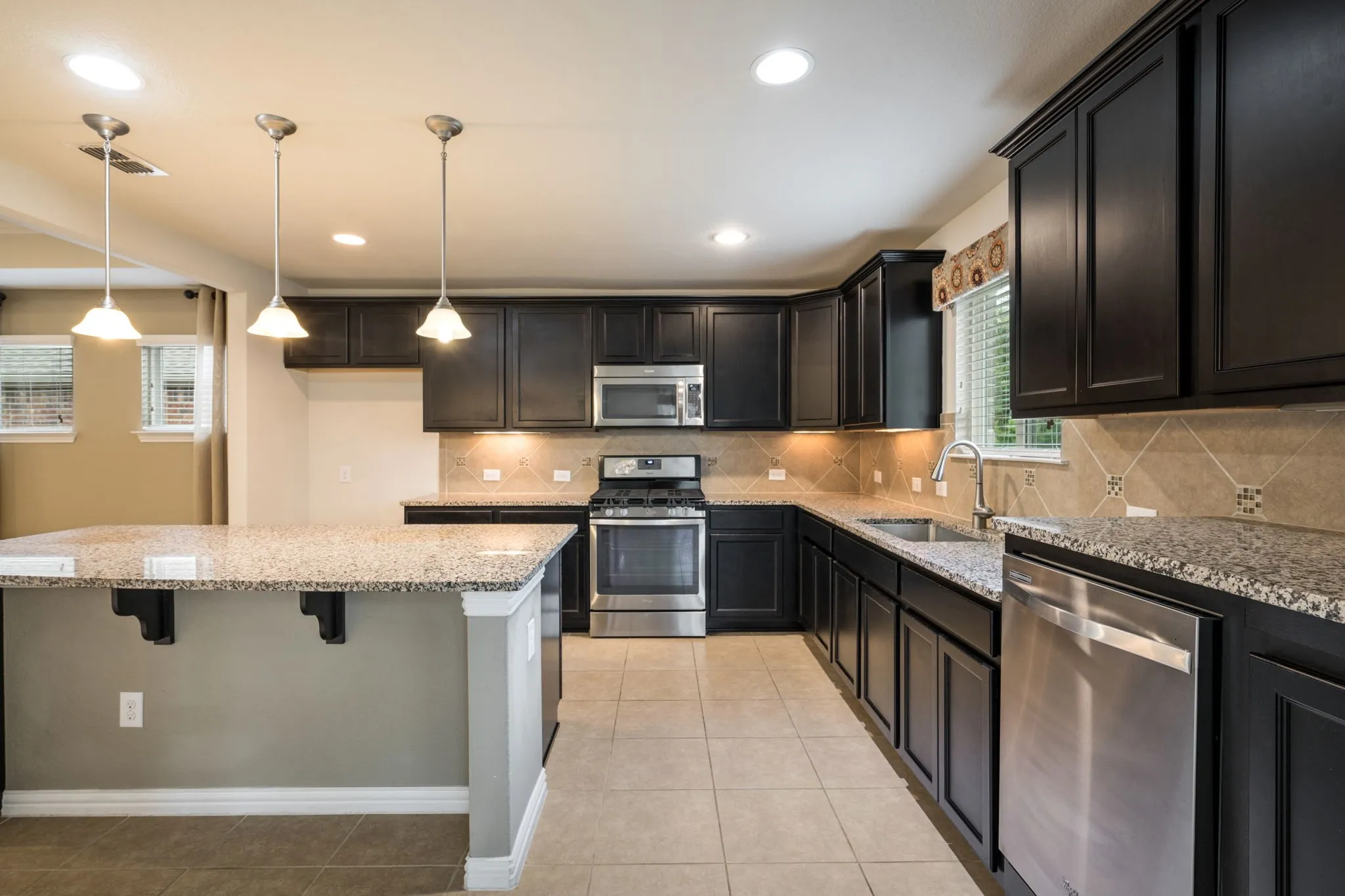 Dream Kitchen with granite counters, tile backsplash, SS appliances and large Island.