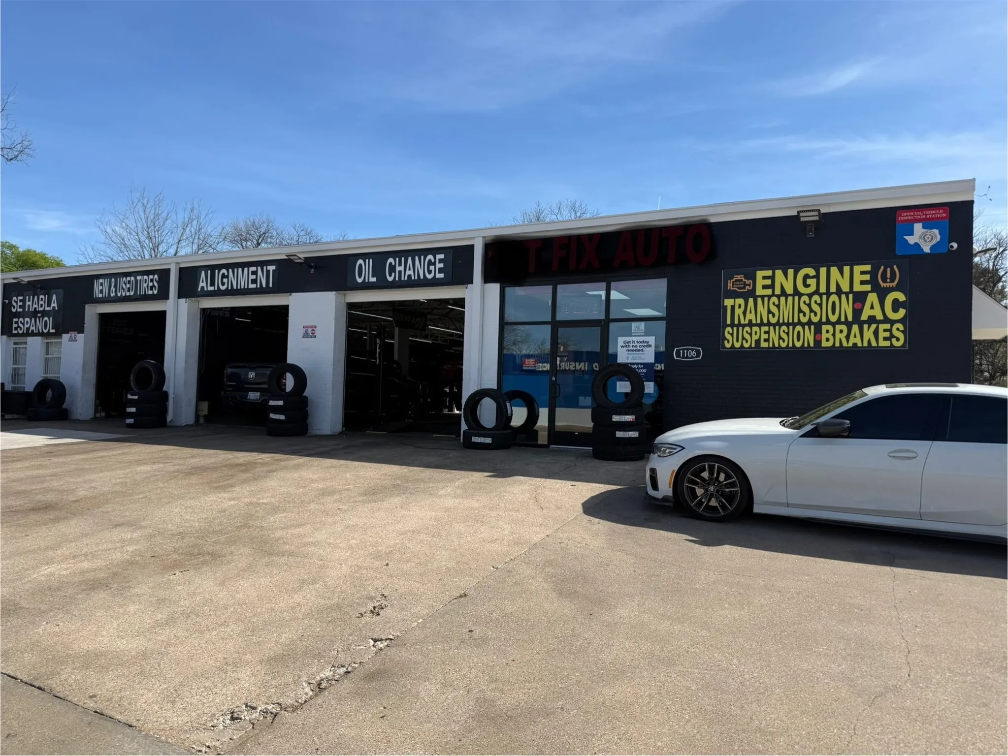 The property features a storefront with large windows and a service area with three garage bays