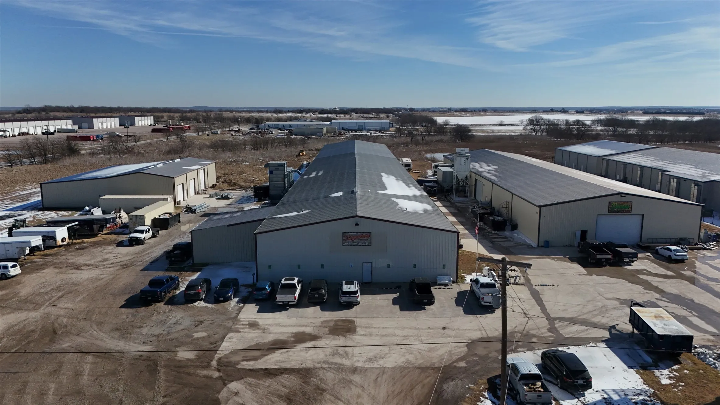 Expansive industrial property featuring multiple large buildings with metal exteriors and roofs
