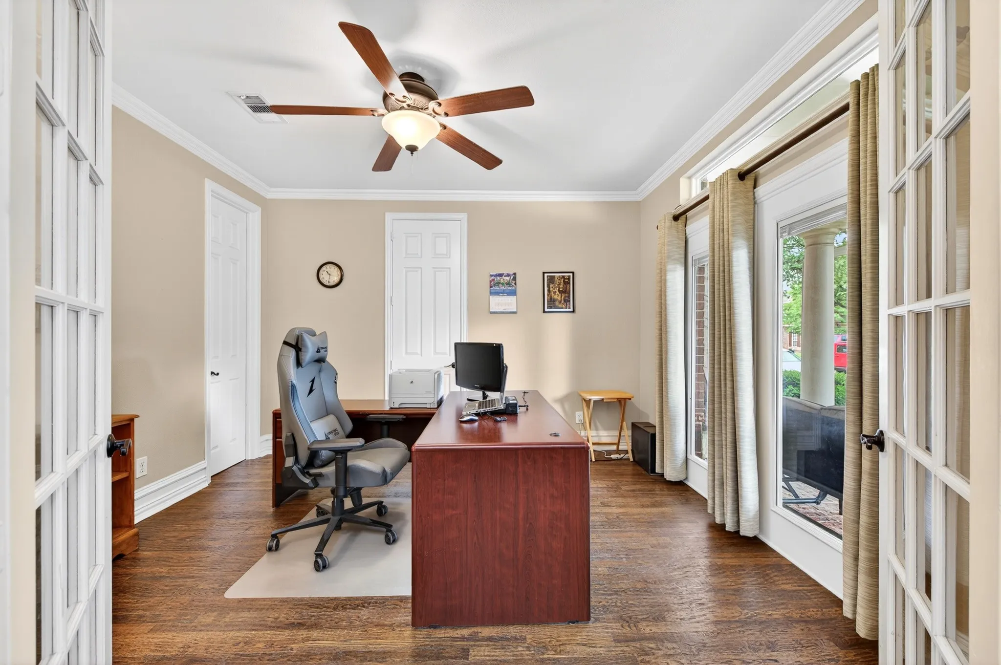 Home office featuring wood-finish flooring, french doors and white crown molding