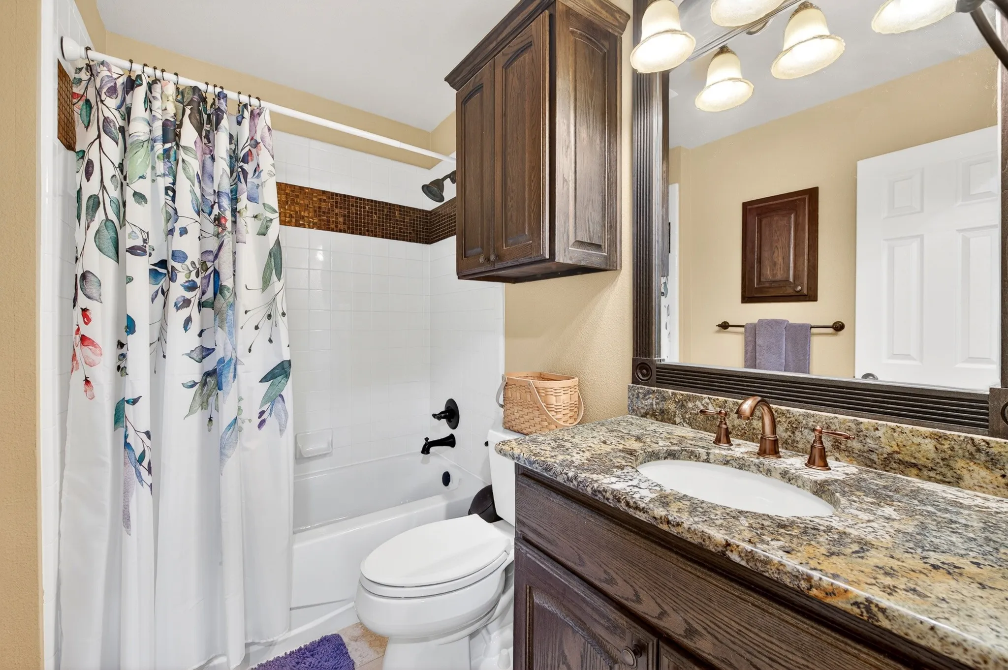 Second floor Bathroom featuring a dark wood-finish vanity with granite countertop, an under mount sink, and bronze-finish fixtures