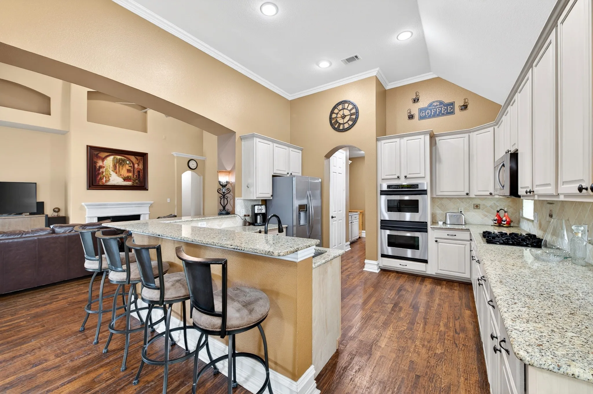 Open-concept kitchen featuring wood-finish flooring, light-toned cabinetry, granite countertops, and recessed​​‌​​​​‌​​‌‌​‌‌​​​‌‌​‌​‌​‌​​​‌​​ lighting