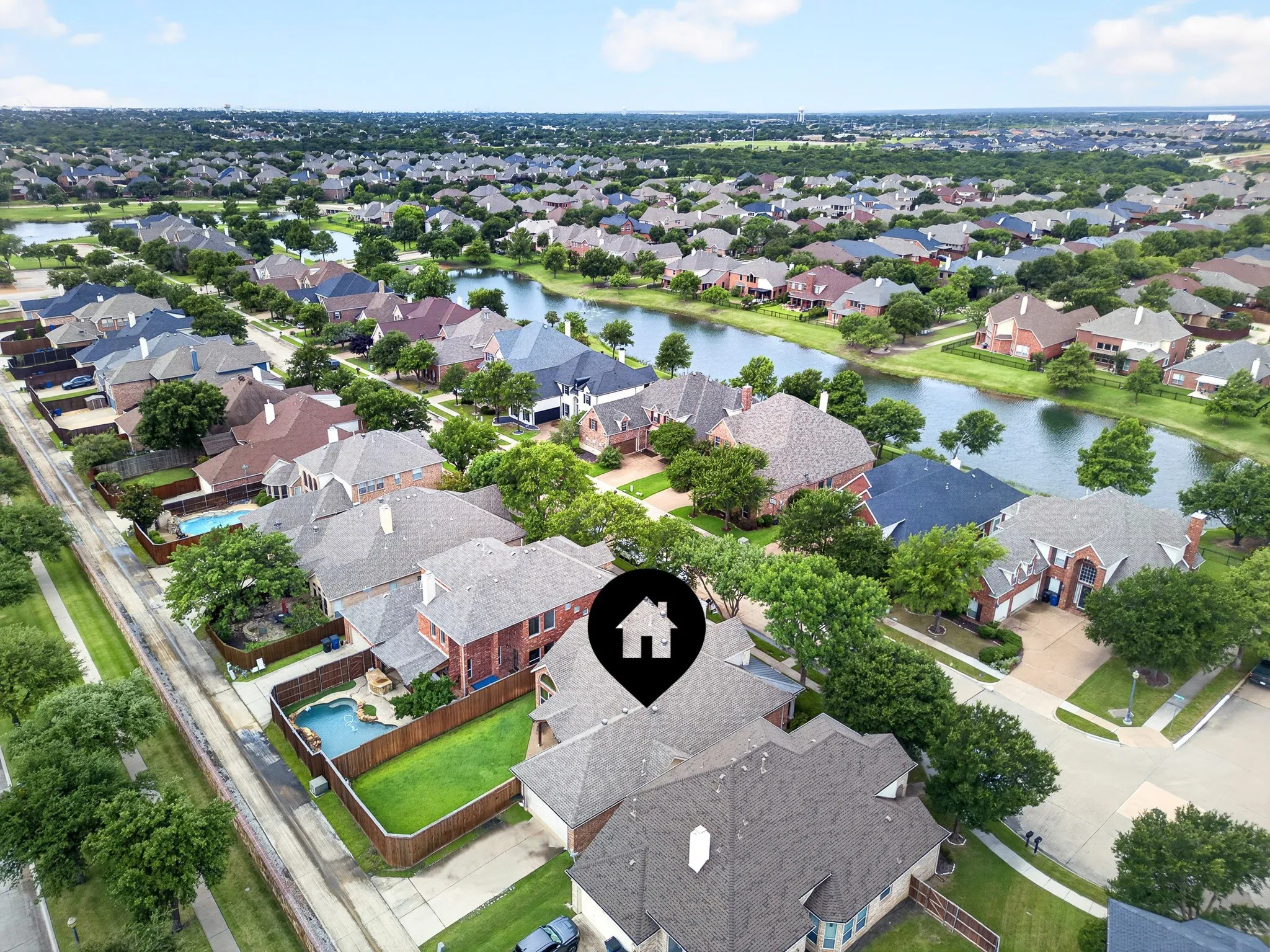Aerial perspective showcasing a residential neighborhood with numerous homes featuring varied architectural styles and roofing materials