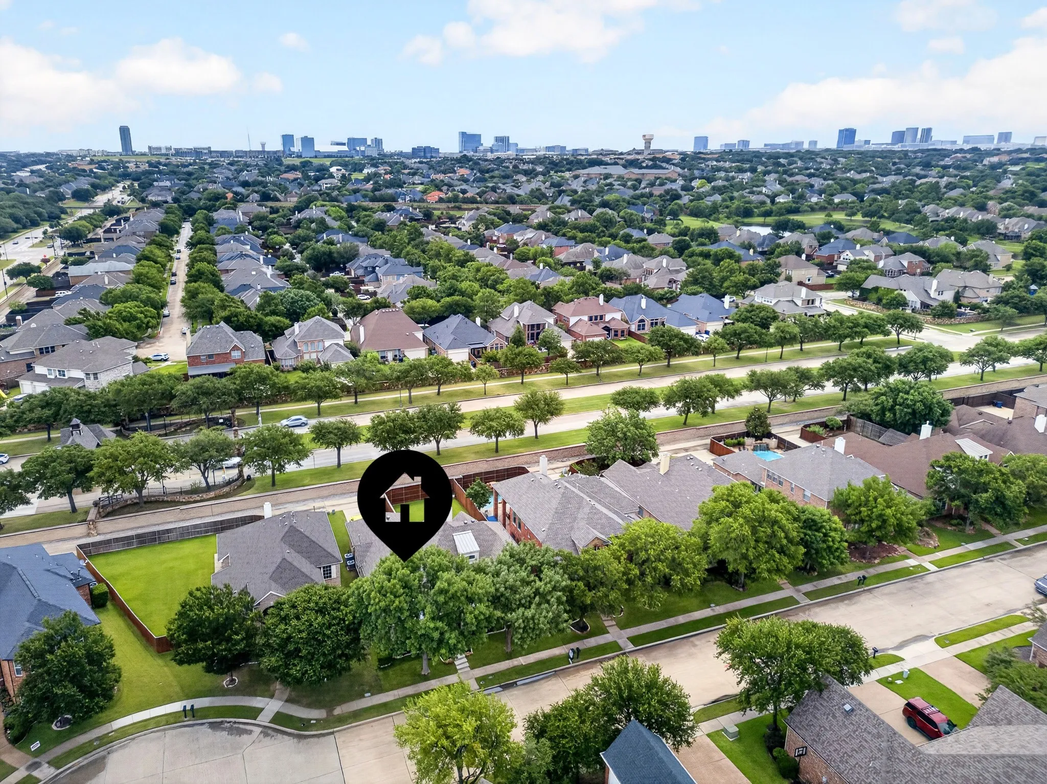 Aerial perspective highlighting a residential neighborhood with tree-lined streets and a distant skyline
