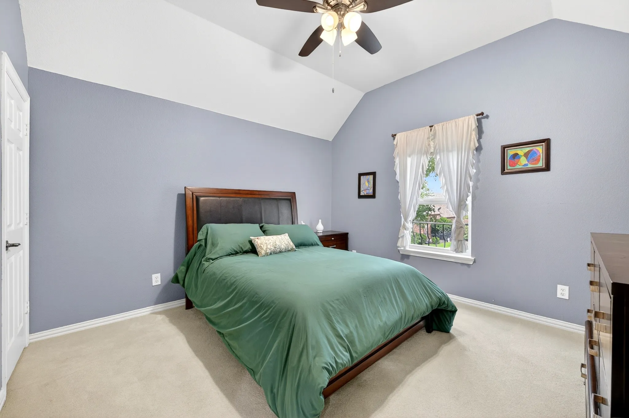 Second floor Bedroom featuring a vaulted ceiling, ceiling fan with integrated lighting, soft carpet flooring, and a window with natural light