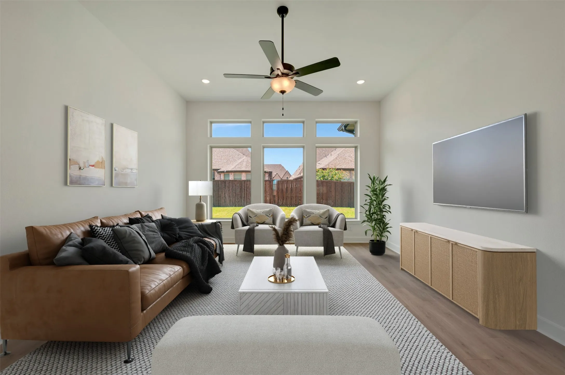 Vaulted ceilings with recessed lighting, wood-finish flooring, and a ceiling fan