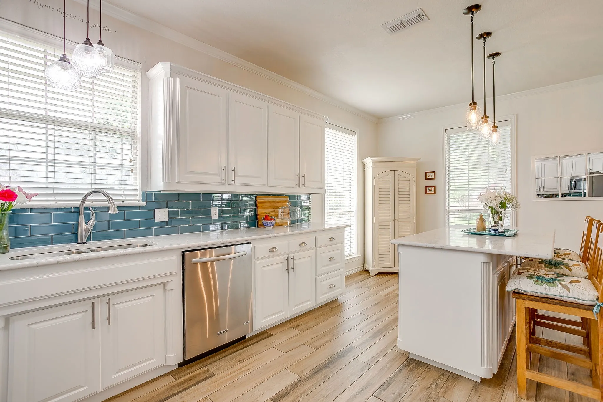 Tile backsplash and pendant lighting above sink.