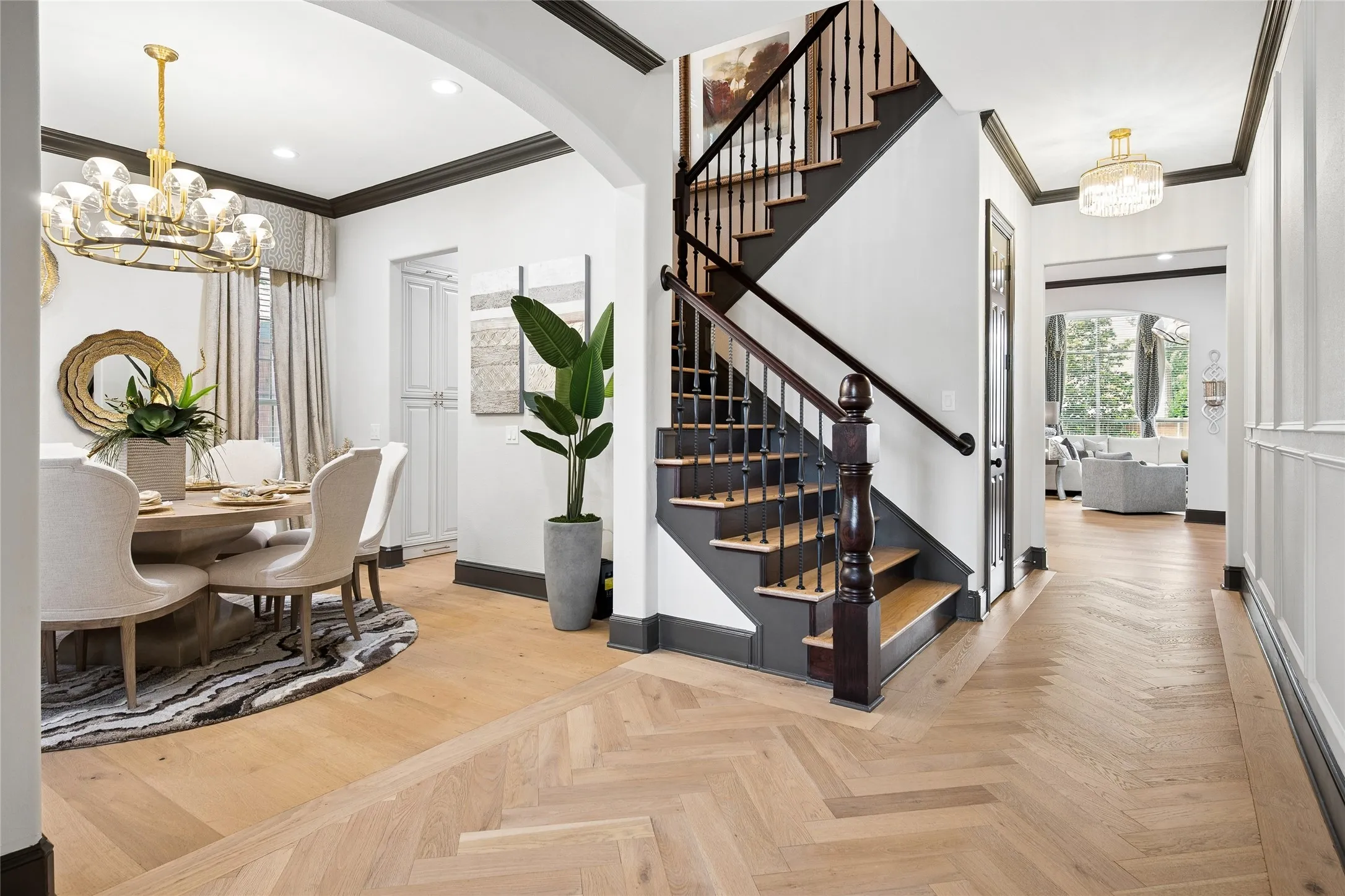 Wood staircase with iron spindles is just past the formal dining room. Storage closet under the stairs.