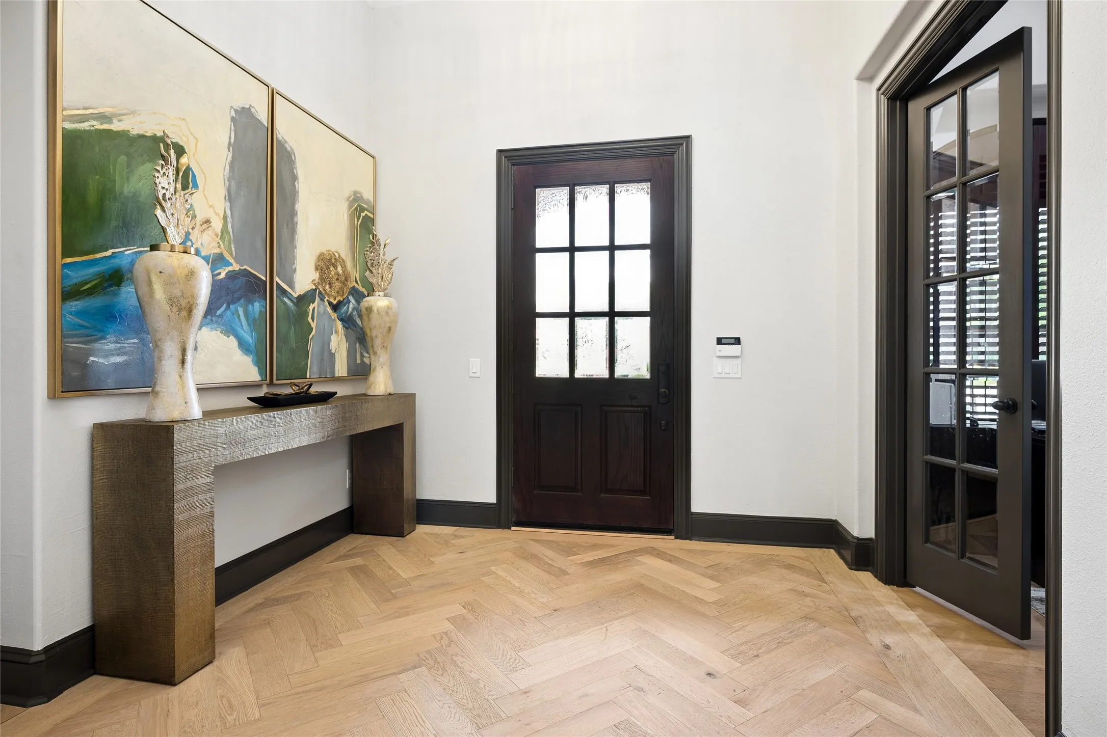 Foyer with white oak hardwood floors that flow throughout the home
