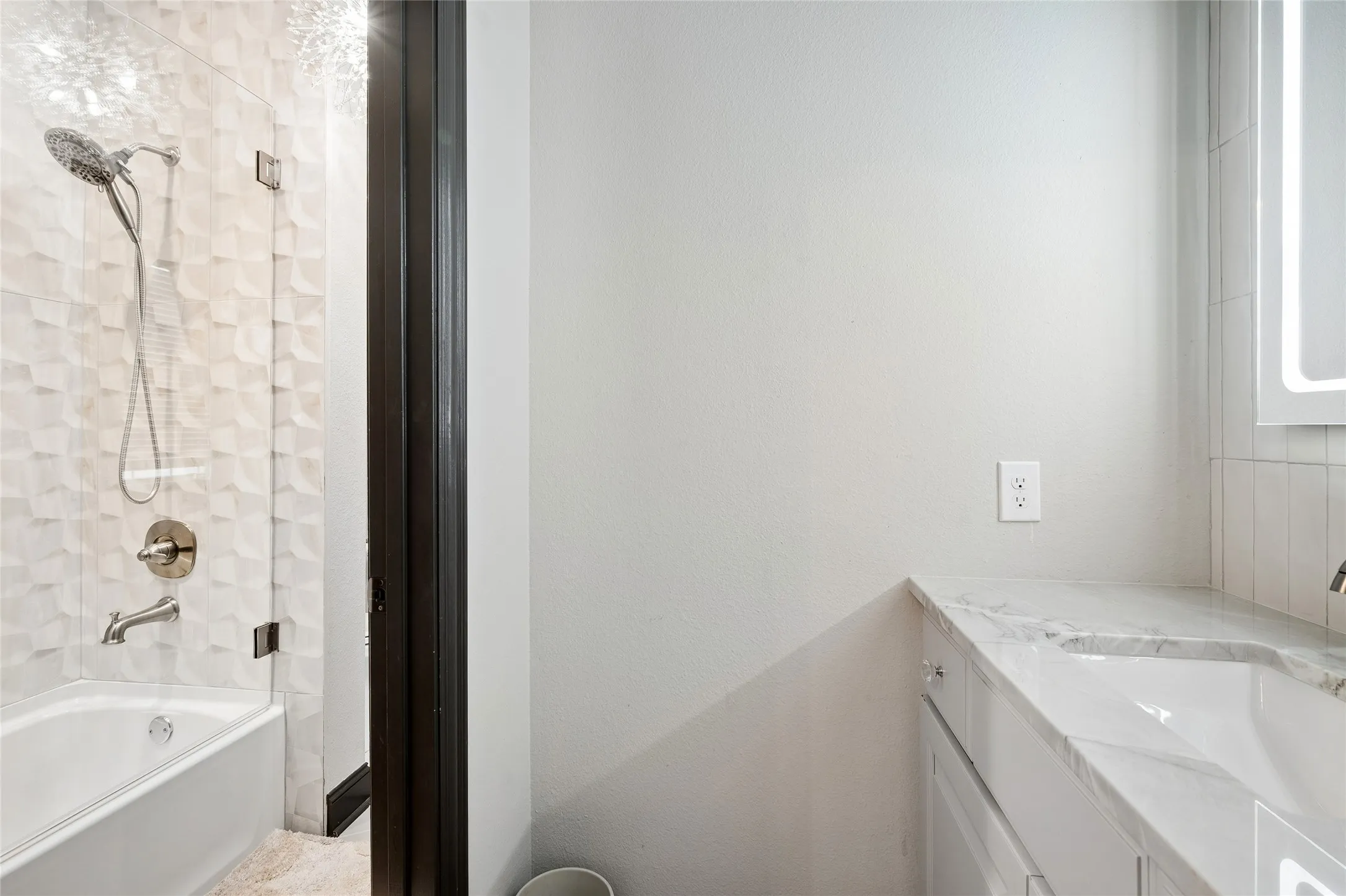 One side of Jack 'n Jill bath showing entry to middle section with combo shower/tub