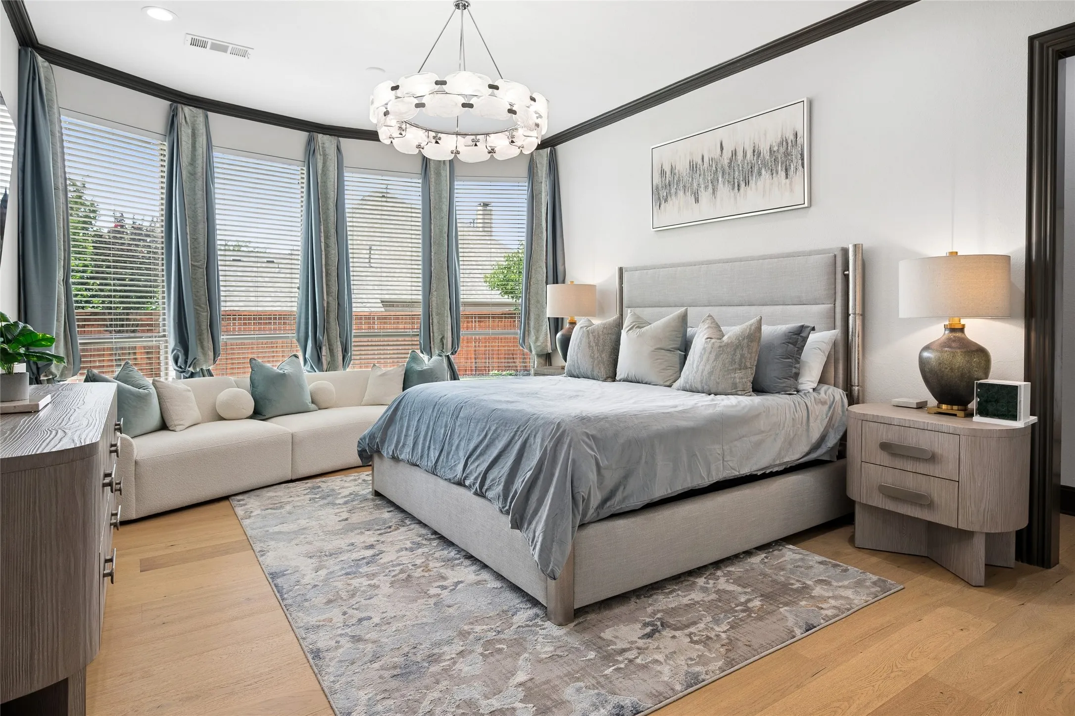 Primary suite with a curved window view and sitting area and a very large walk-in closet with shelves