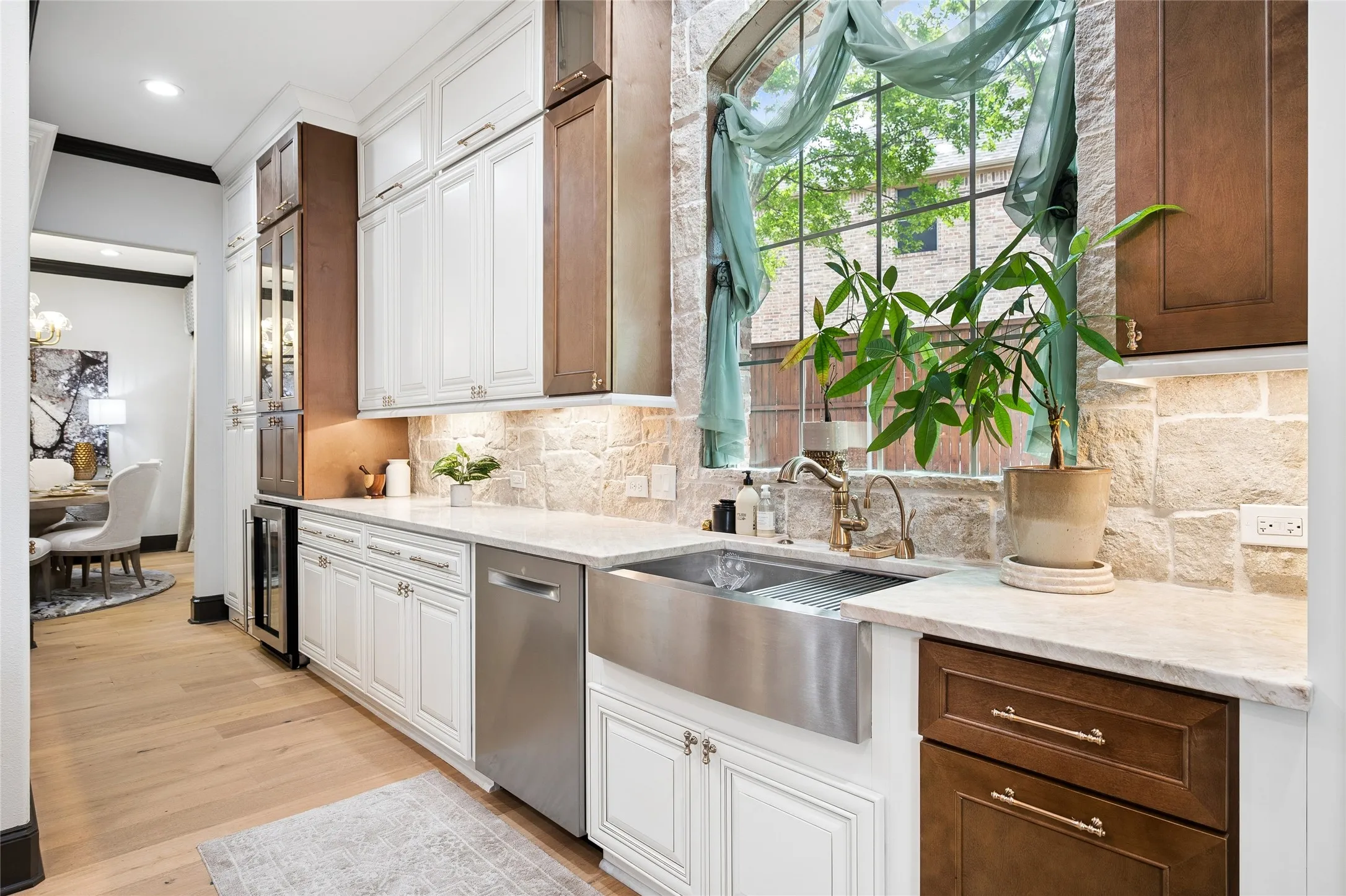 Large window over the apron sink. A lot of cabinets and quartize counters for a very functional kitchen.