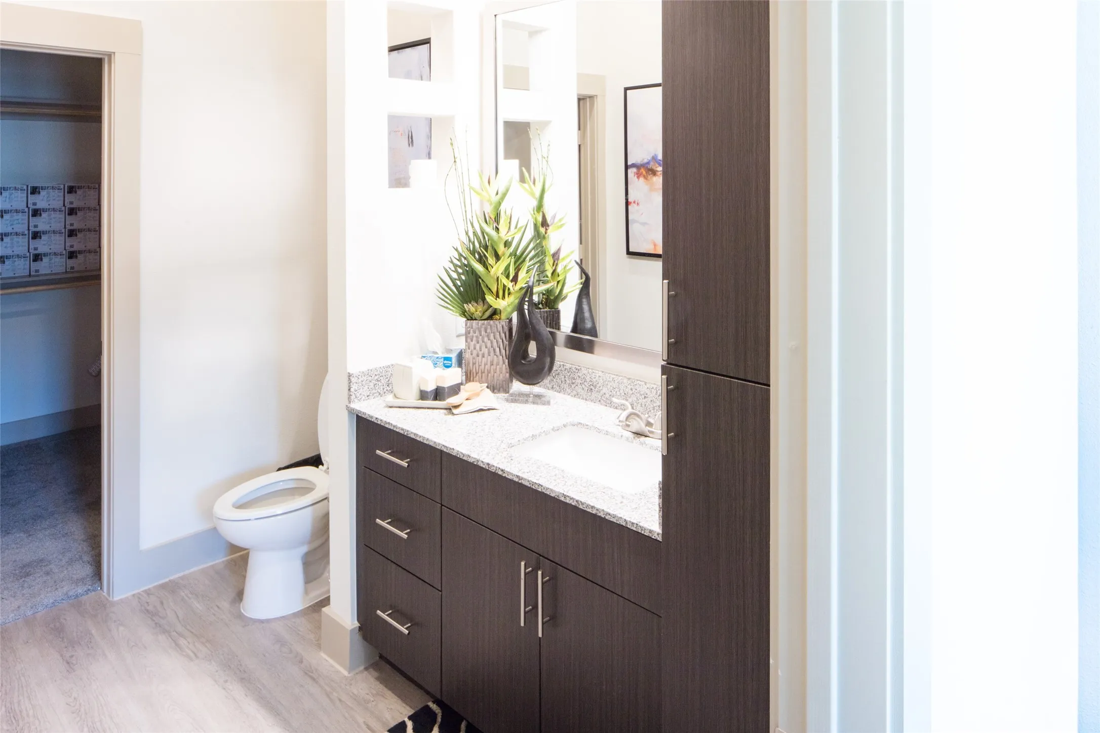 Bathroom featuring hardwood / wood-style floors, vanity, and toilet