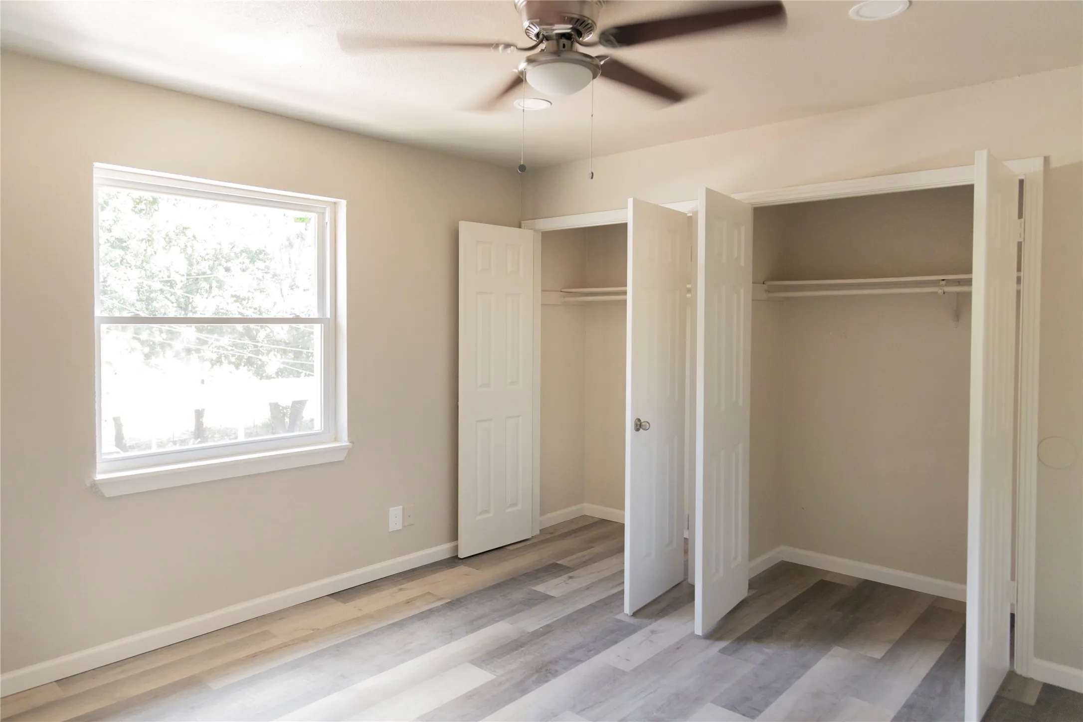 Interior room featuring wood-finish flooring and neutral wall tones