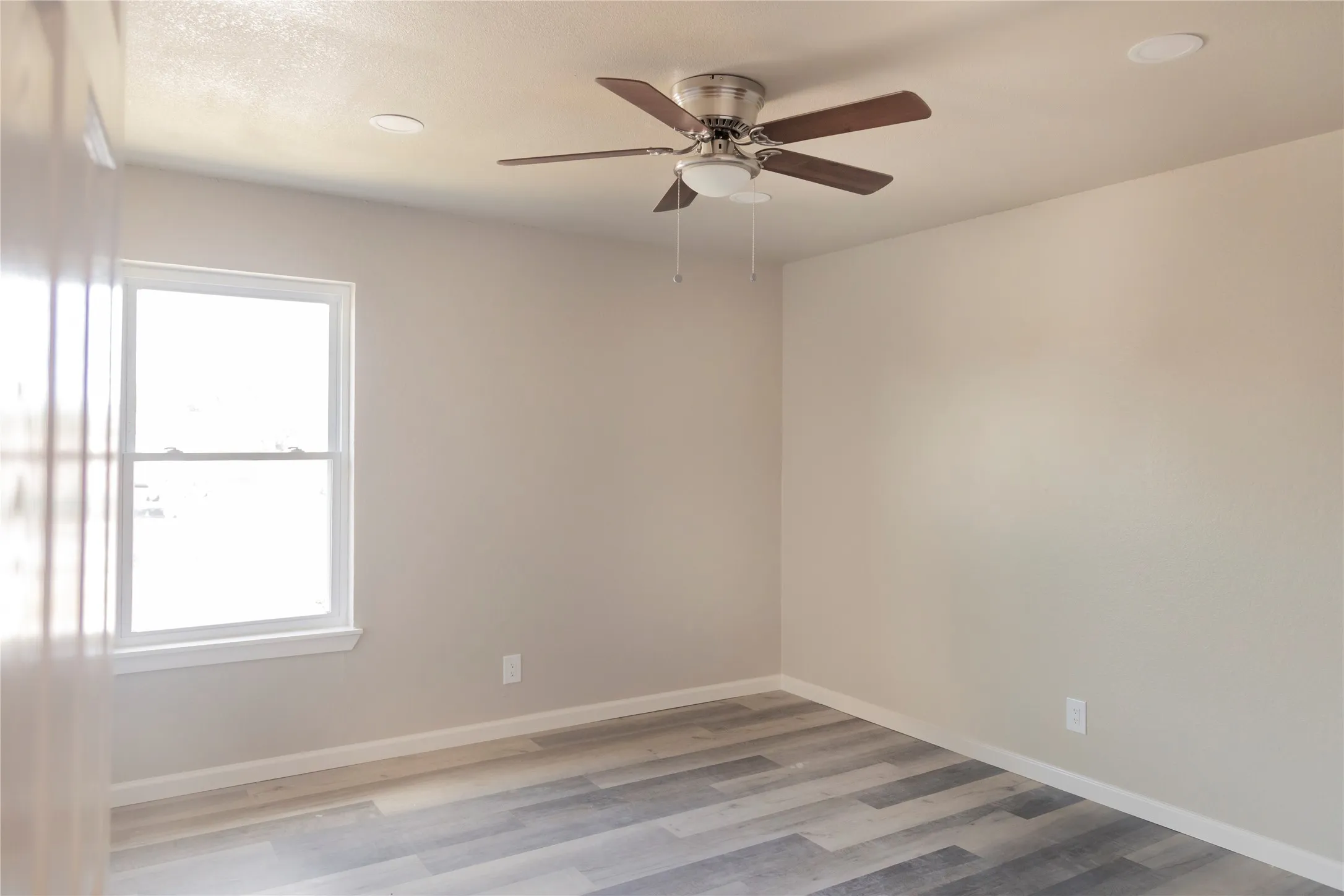 Neutral-toned walls complement wood-finish flooring
