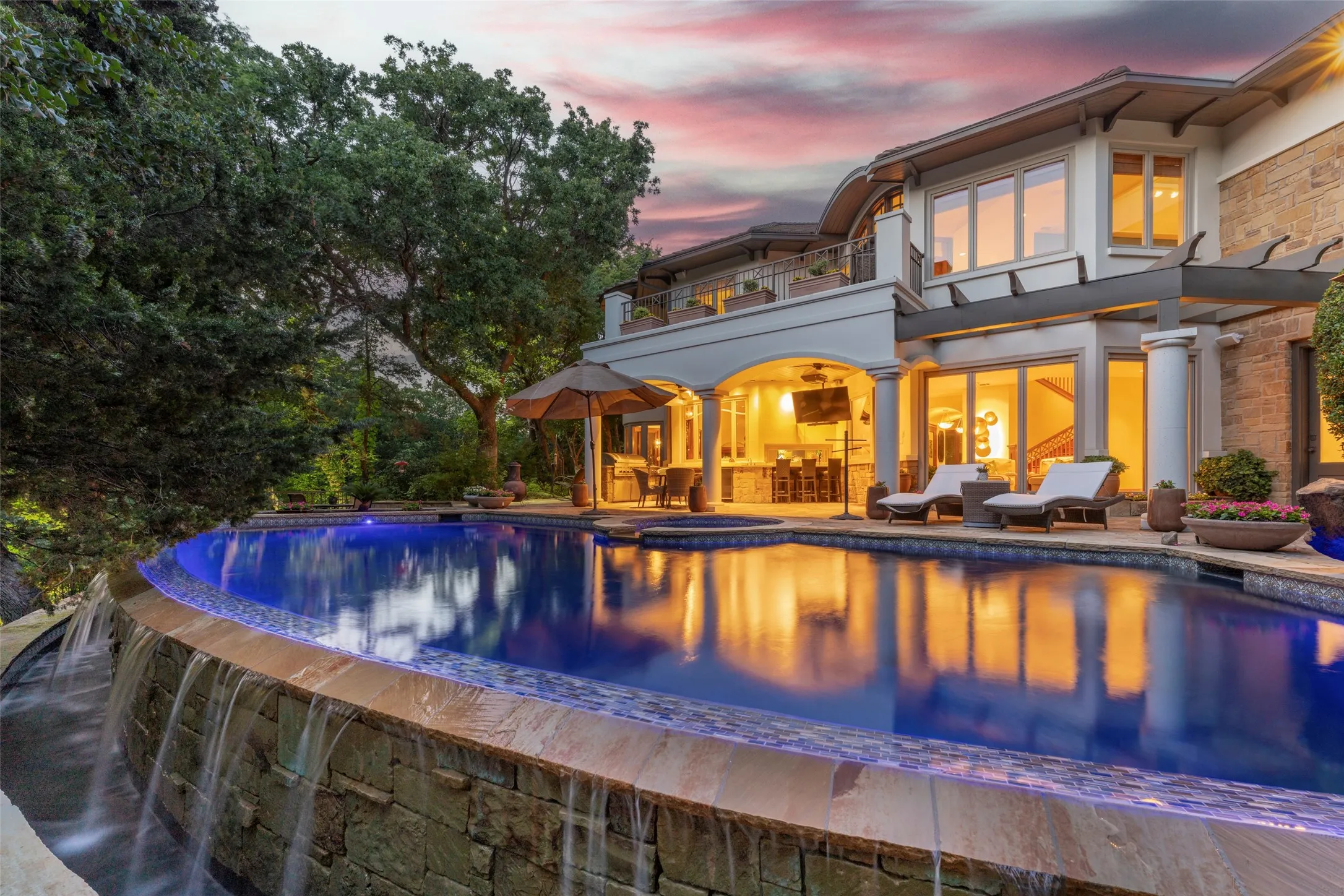Breathtaking view of the pool & natural setting,
outdoor kitchen, patios and lounging areas.