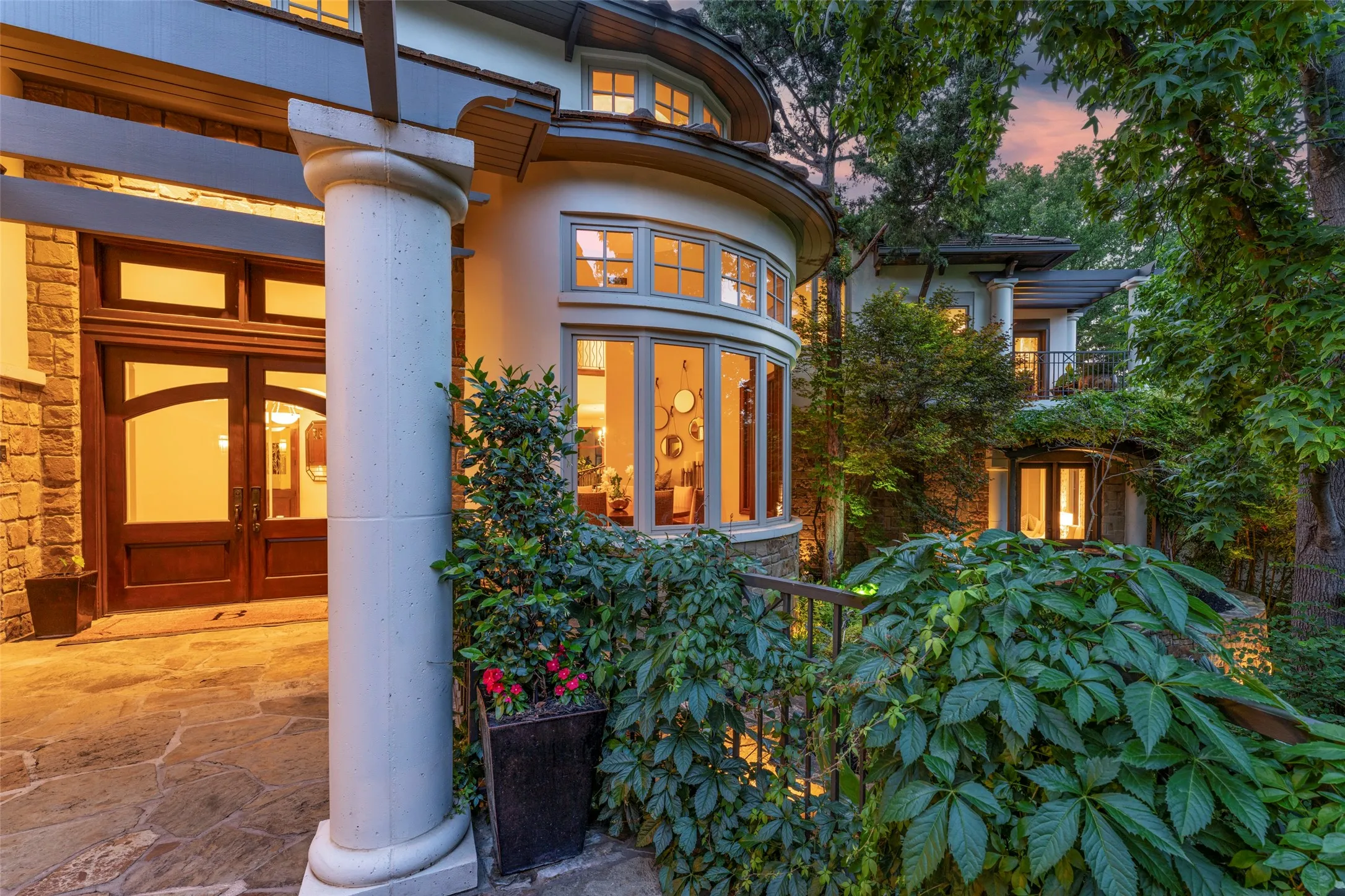 Twilight photo of front entrance and formal dining windows.