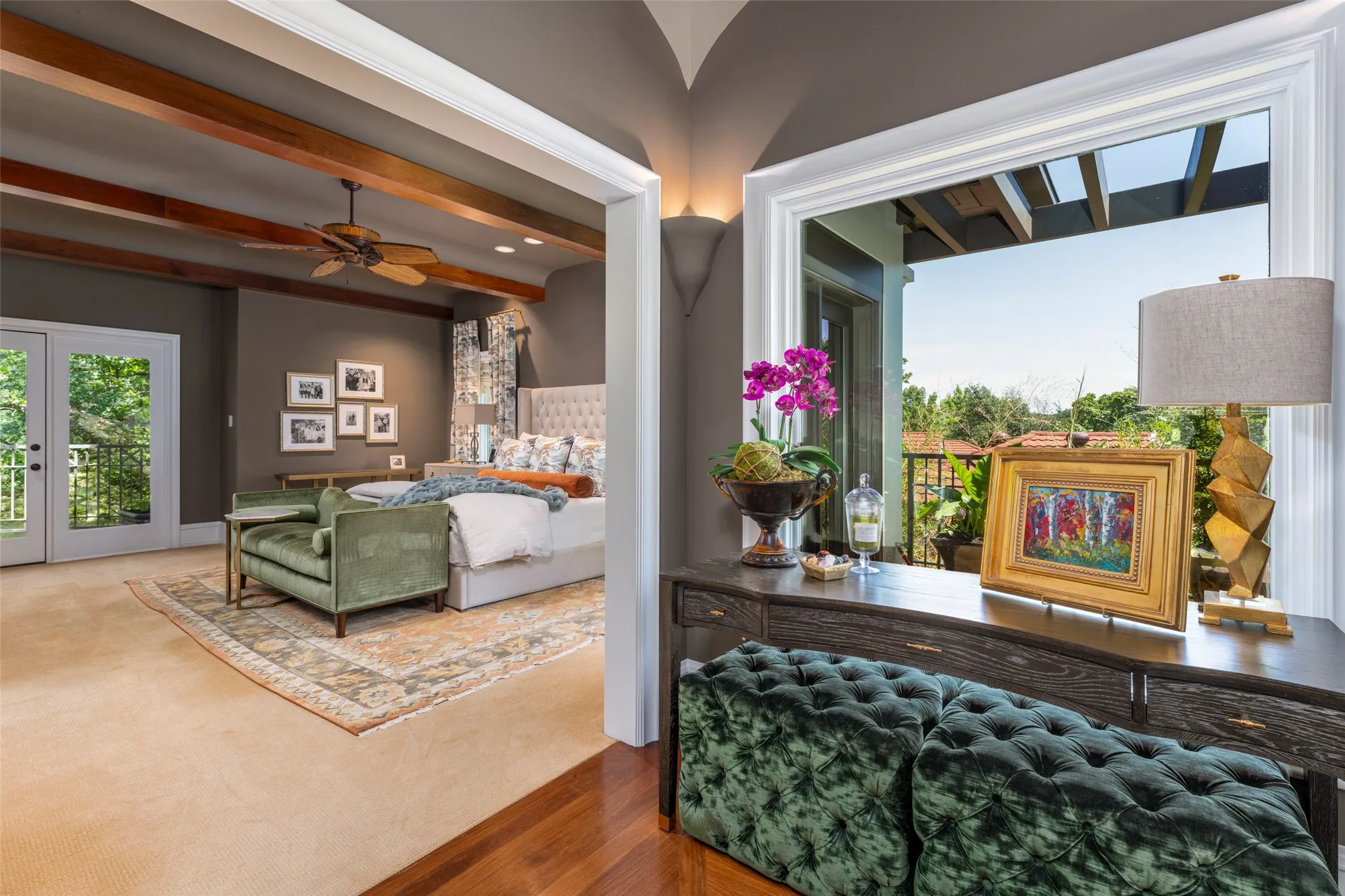 Entry into the primary bedroom with a lovely view from one of several upstairs balconies.