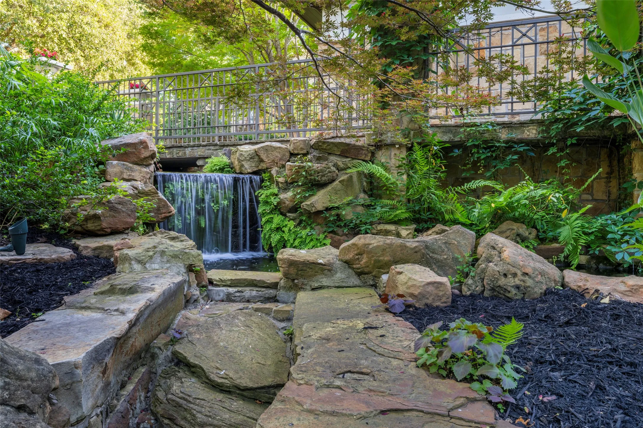 Gentle waterfall spilling over rock in a beautiful,
natural setting.