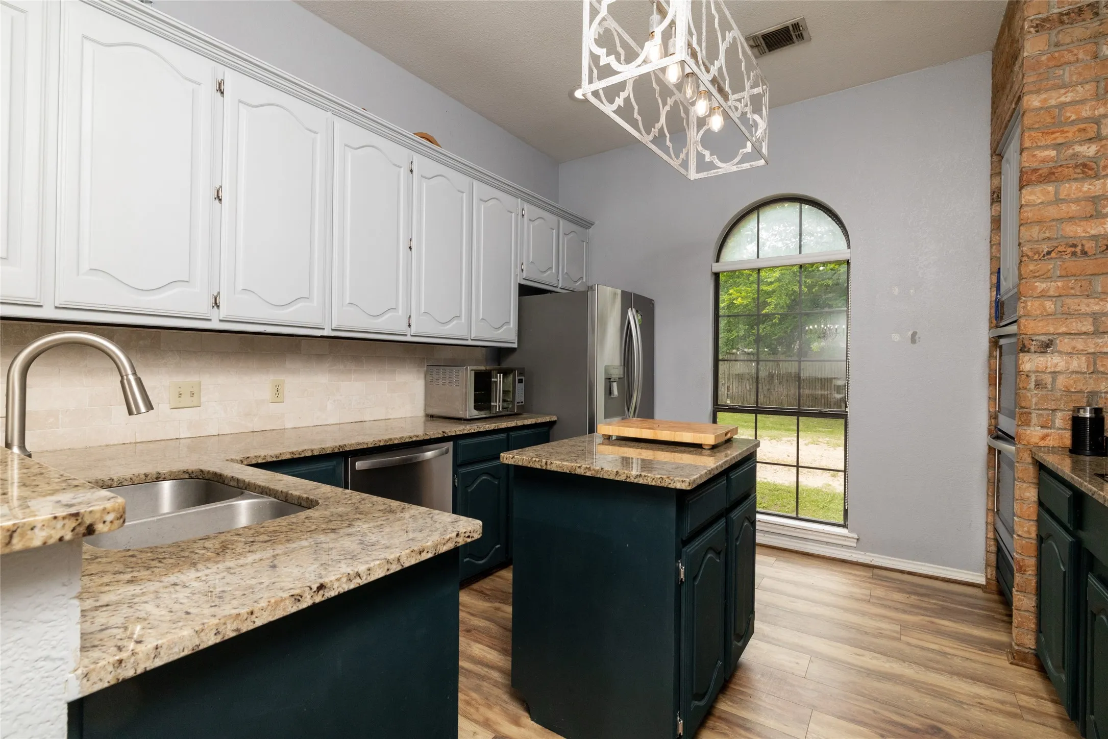Kitchen featuring wood-look flooring and a central island