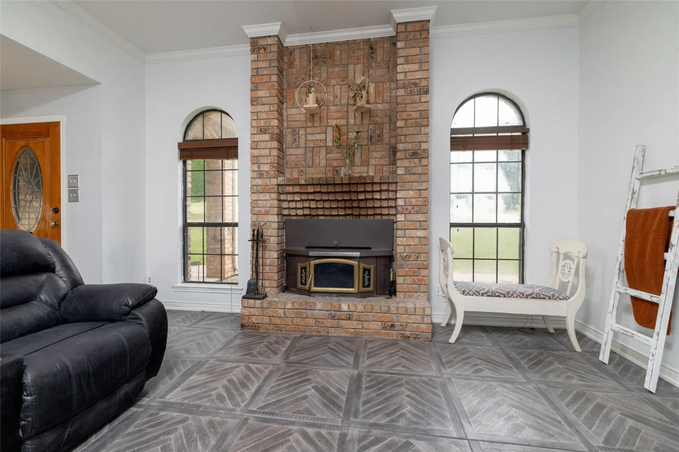 Brick fireplace with hearth and wood-burning insert