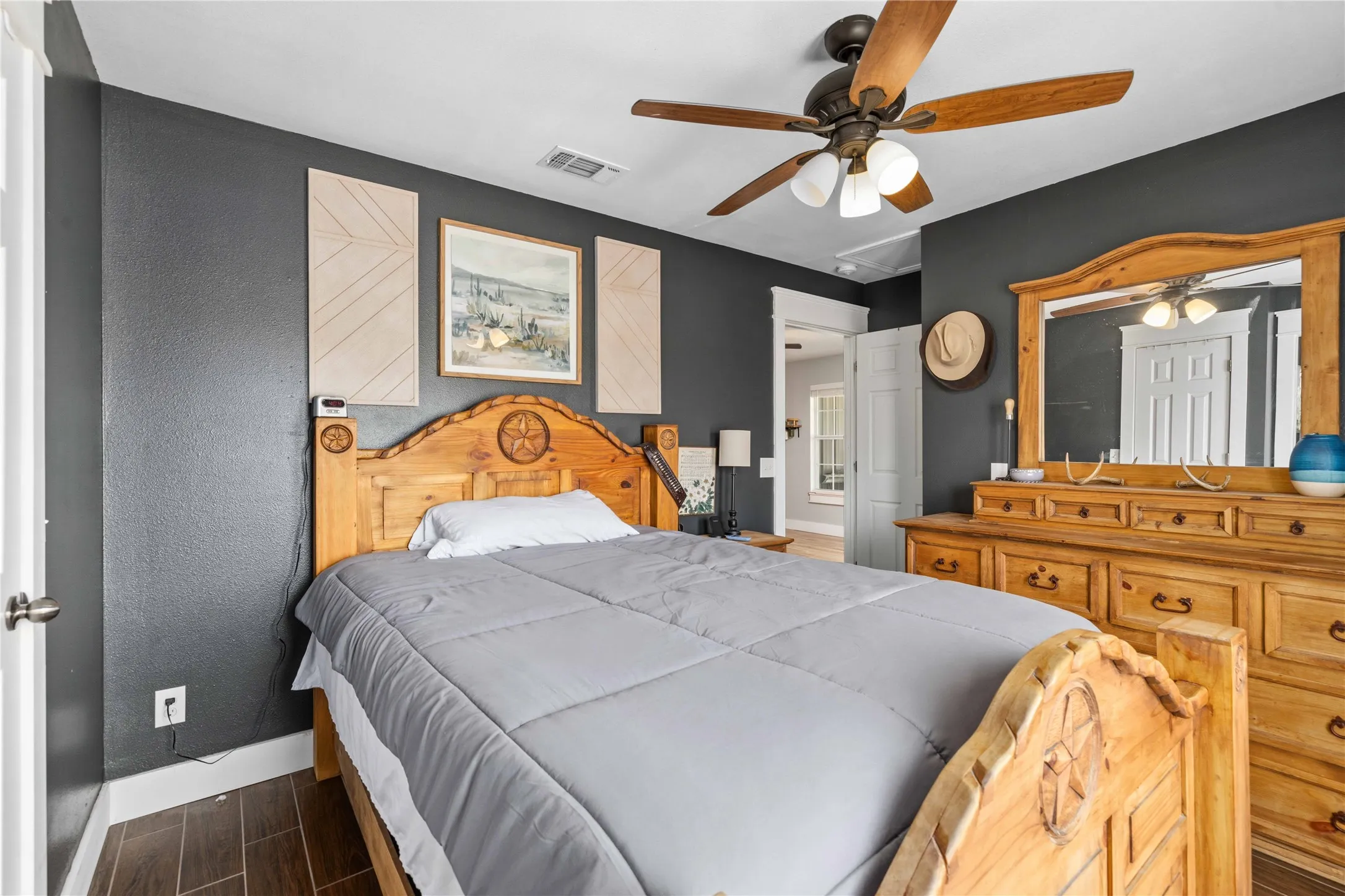 Wood-finish plank flooring complements dark walls