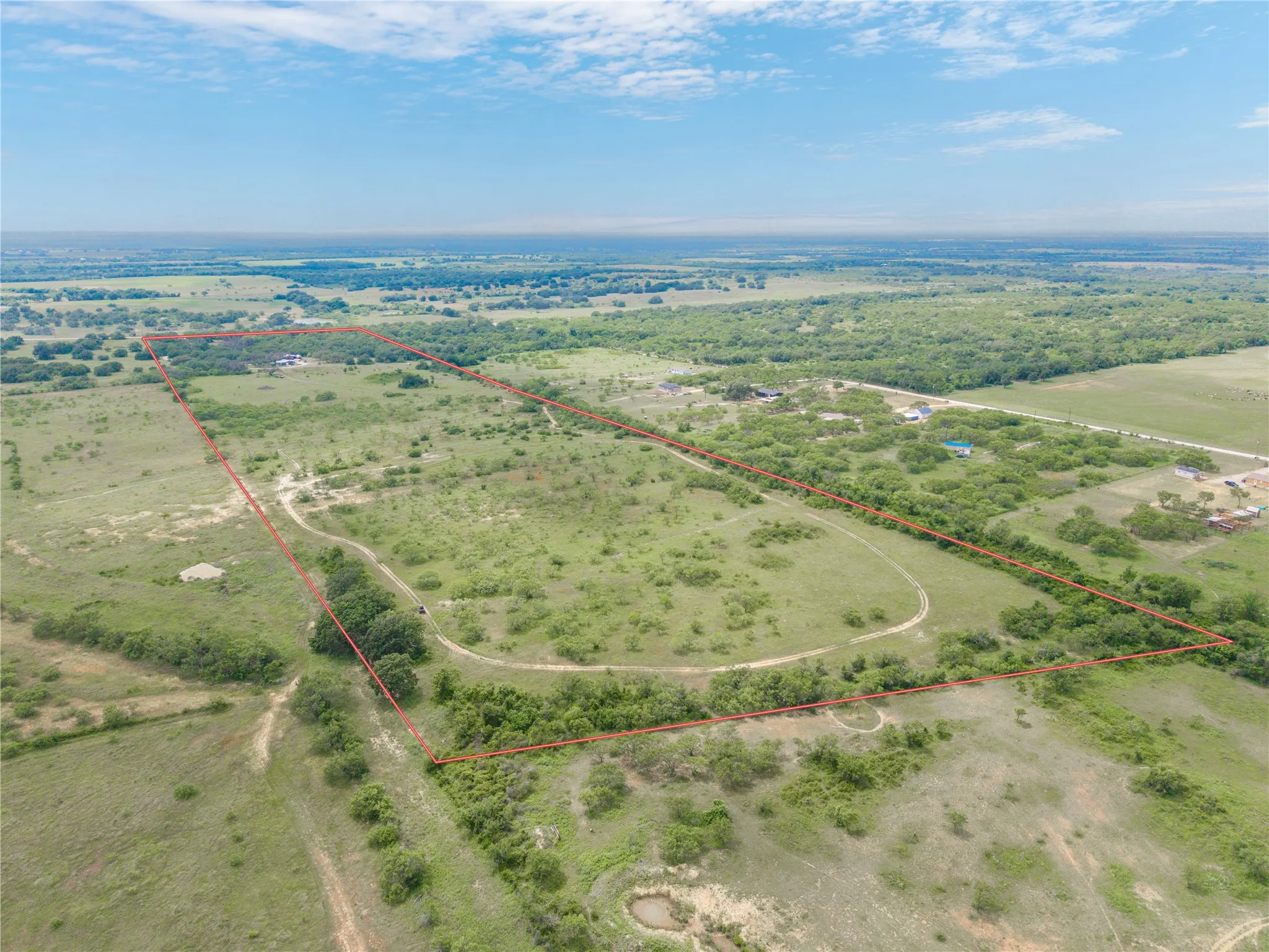 Expansive acreage featuring a mix of open fields and scattered mature trees